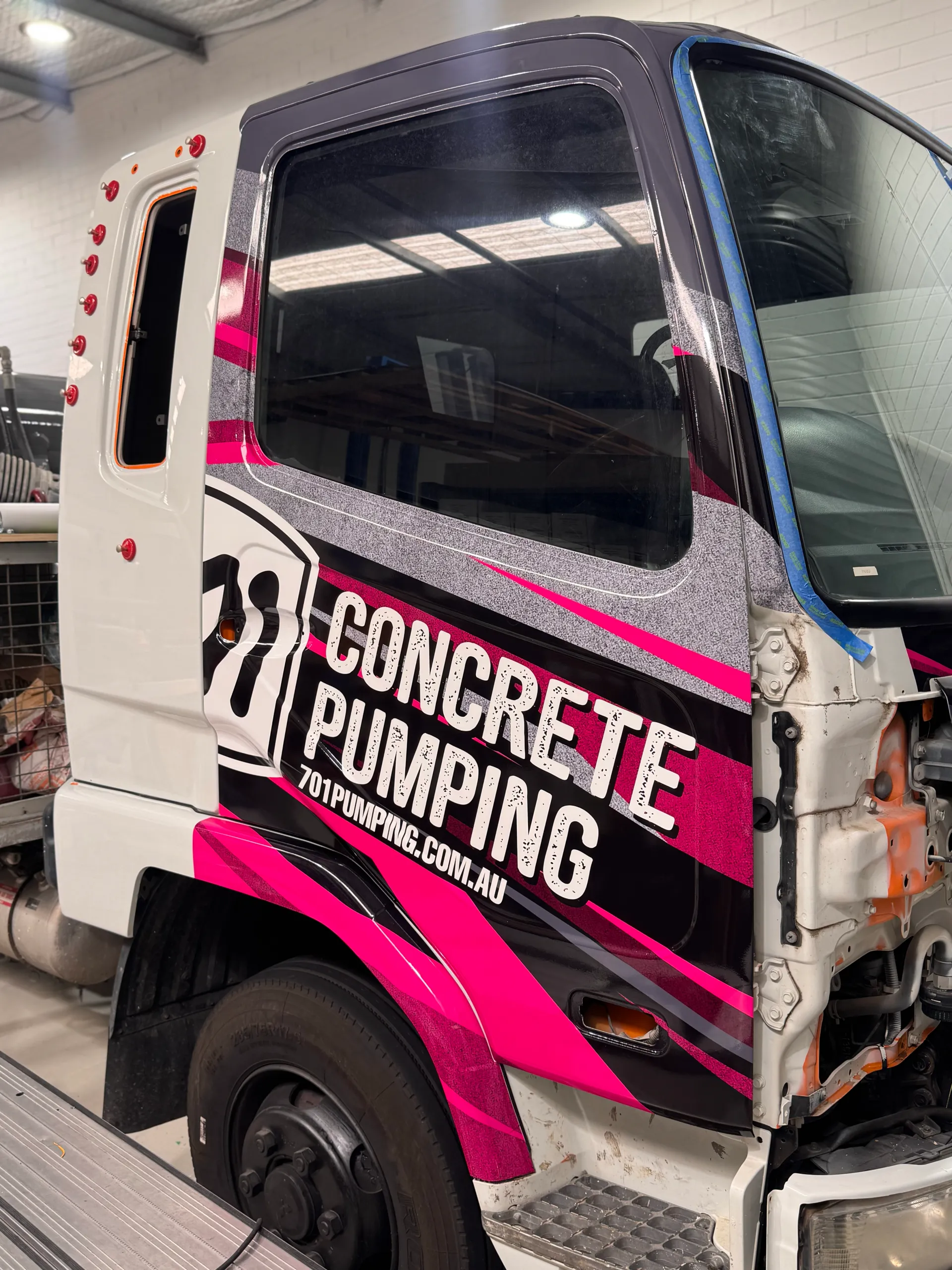 701 Concrete Pumping cab graphics during installation, with front trim removed