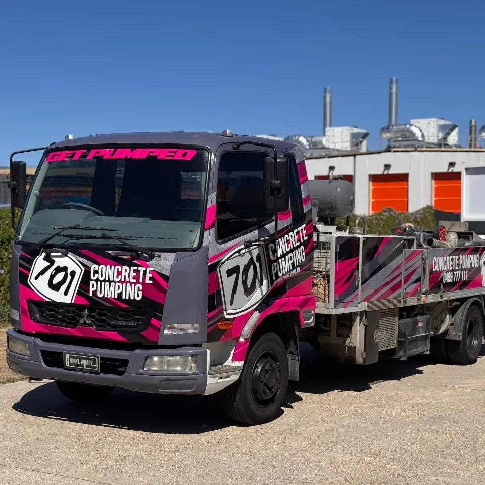 701 Concrete Pumping truck viewed from the front quarter with its branded equipment body behind the cab