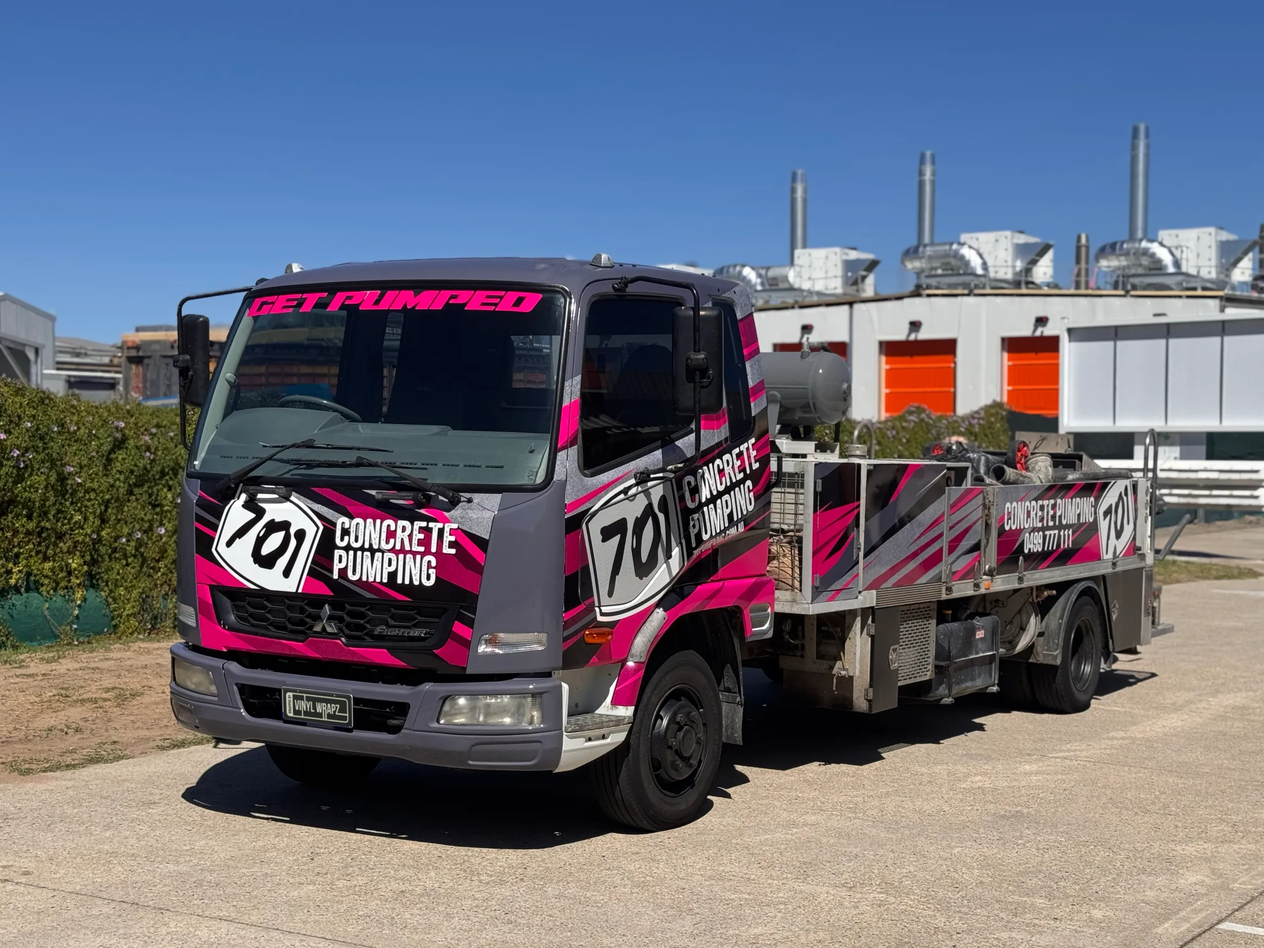 701 Concrete Pumping truck viewed from the front quarter with its branded equipment body behind the cab