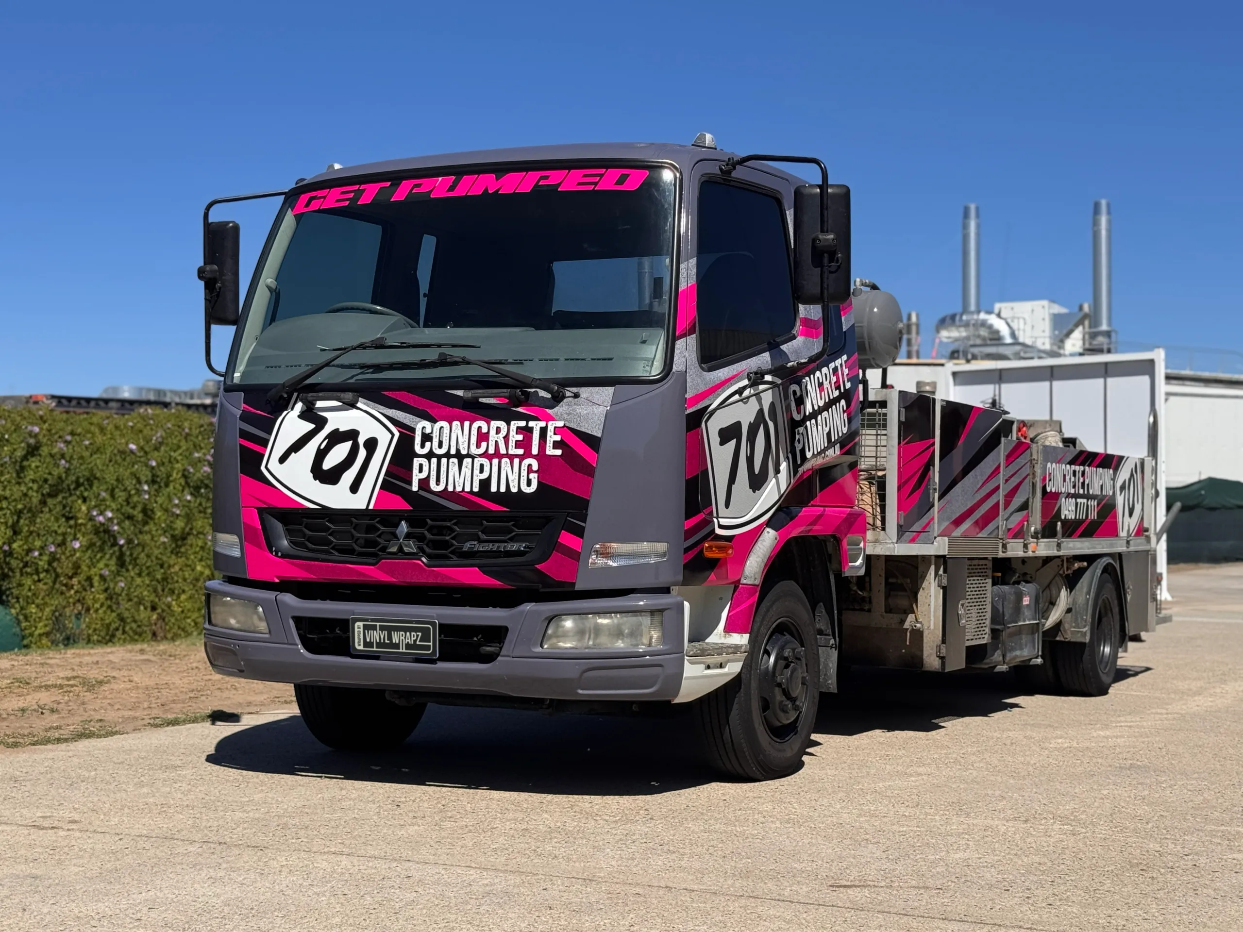 Low front-quarter view of the 701 Concrete Pumping Mitsubishi Fighter truck