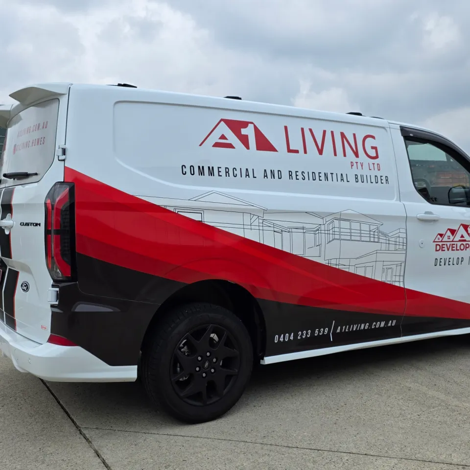 A1 Living Ford Transit Custom with red and black graphics across its white side panels