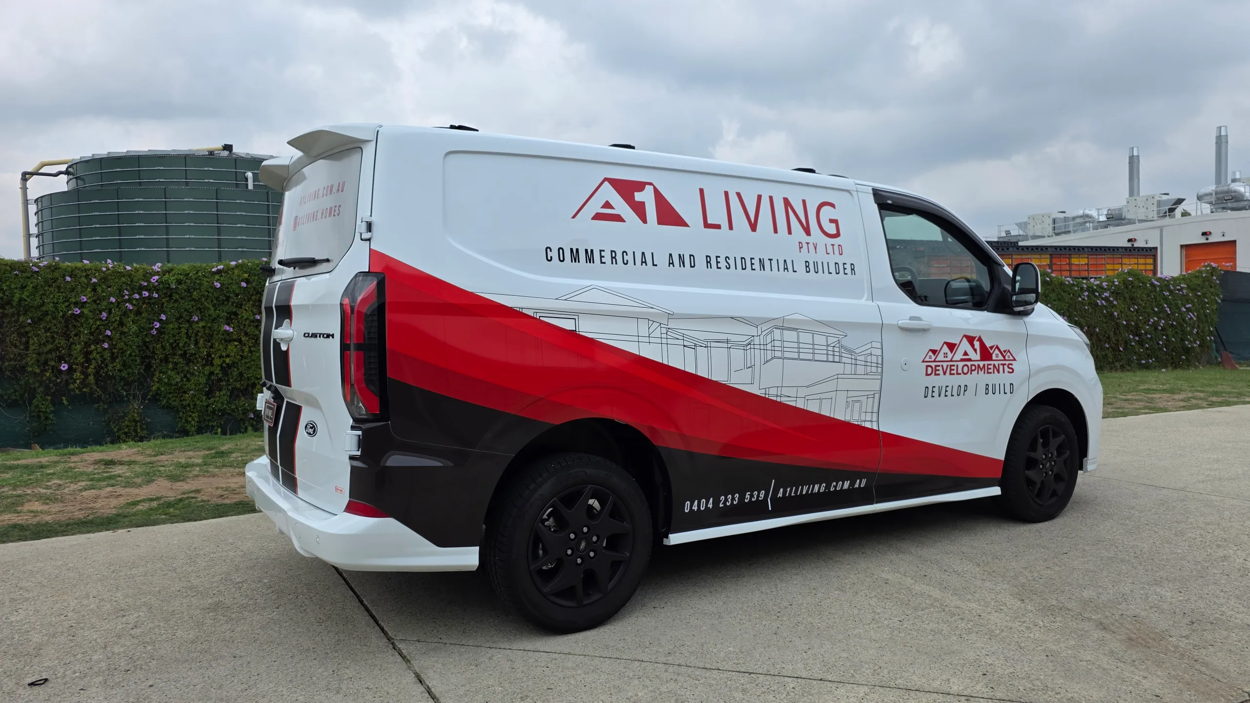 A1 Living Ford Transit Custom with red and black graphics across its white side panels