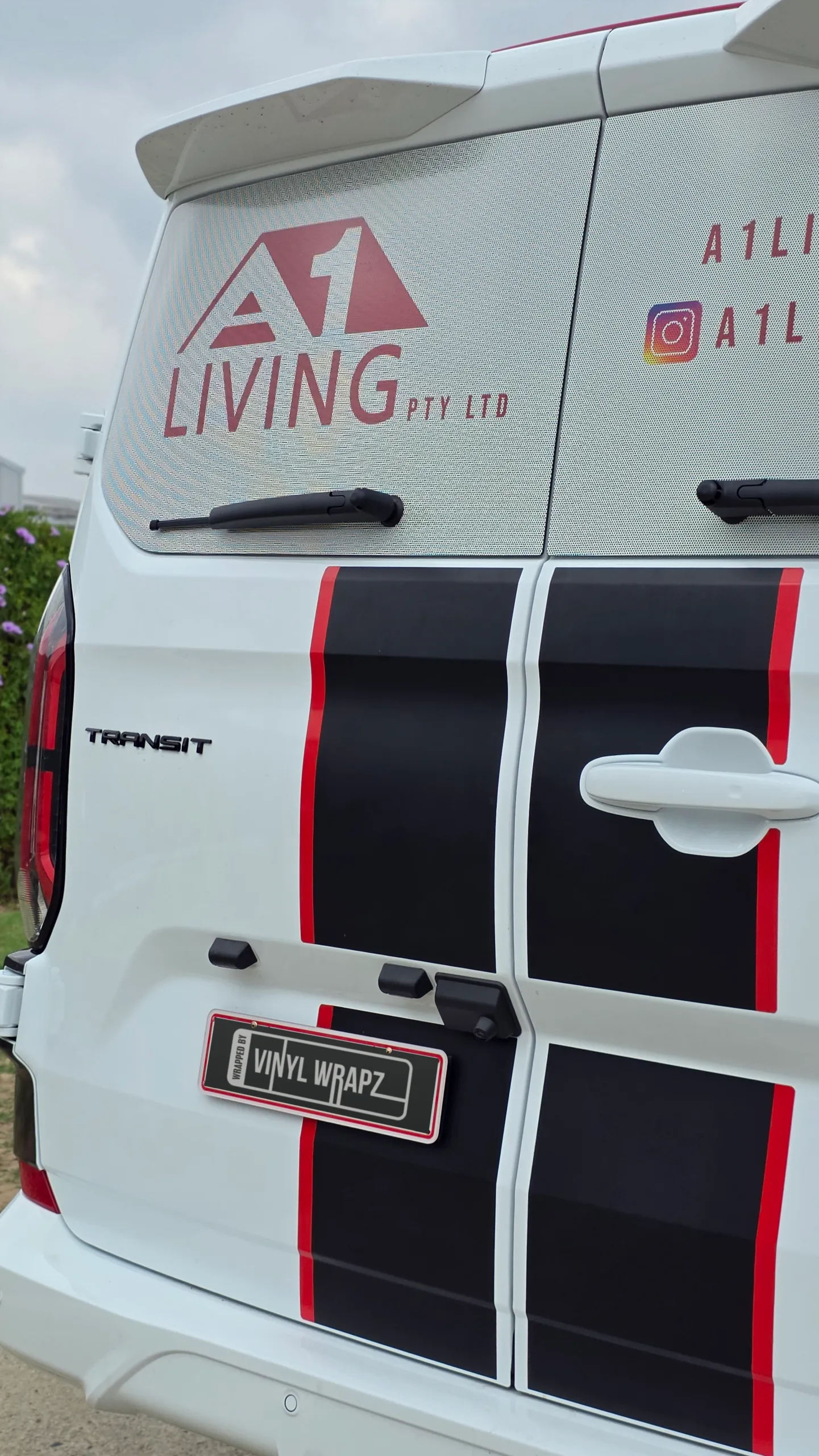 A1 Living branding and black stripes with red edges on the Ford Transit Custom rear doors