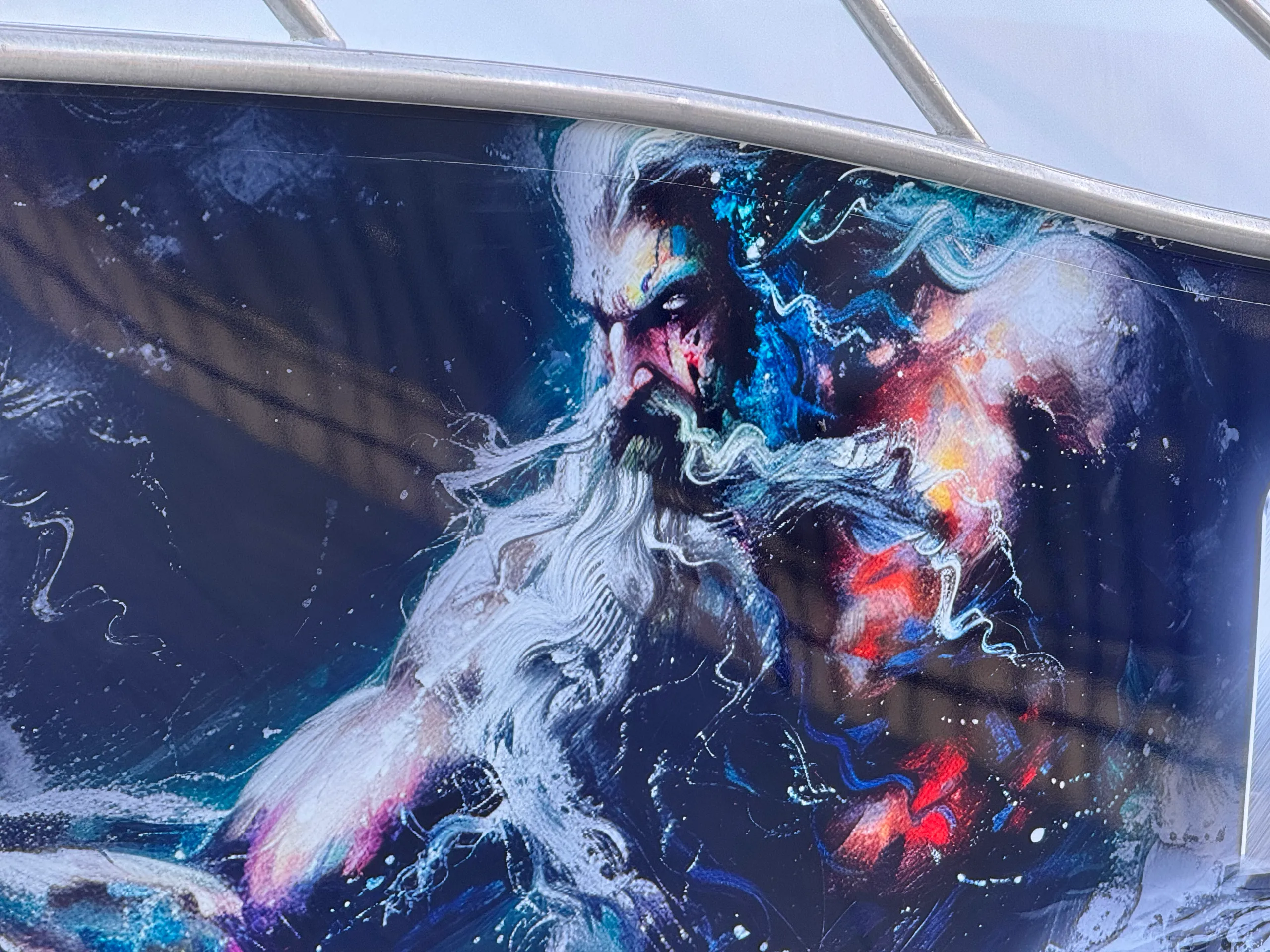 Close-up of the bearded Poseidon character in the dark blue printed boat wrap