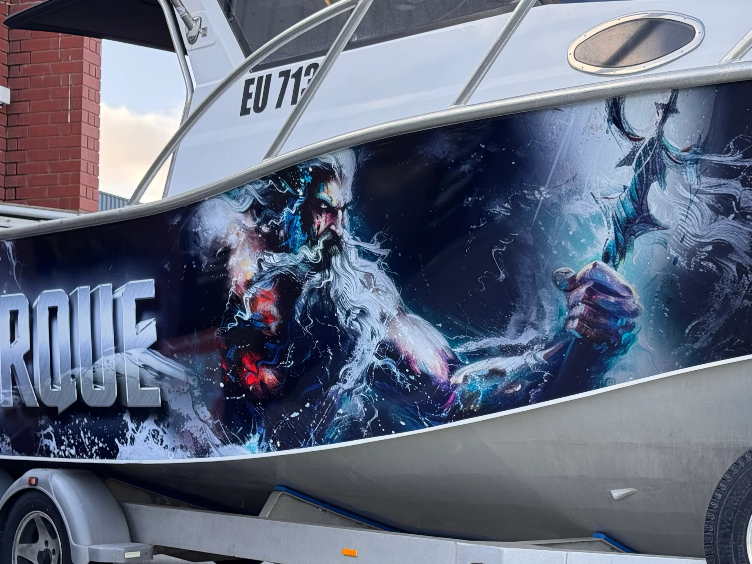 Poseidon holding a trident beside All Torque lettering on the Razerline Olympian hull