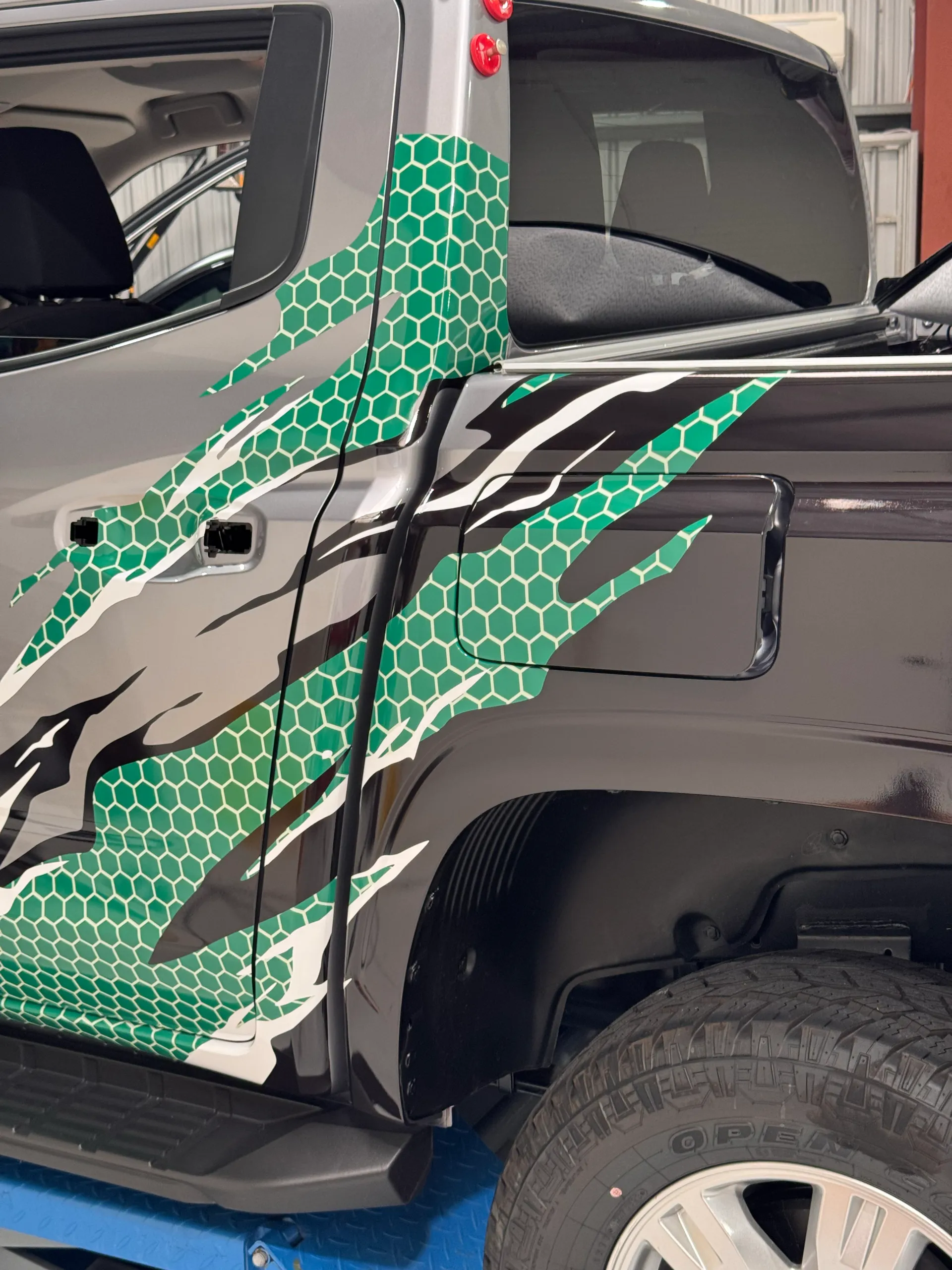 Allied Forklifts graphics during installation across the Triton cab and tray side