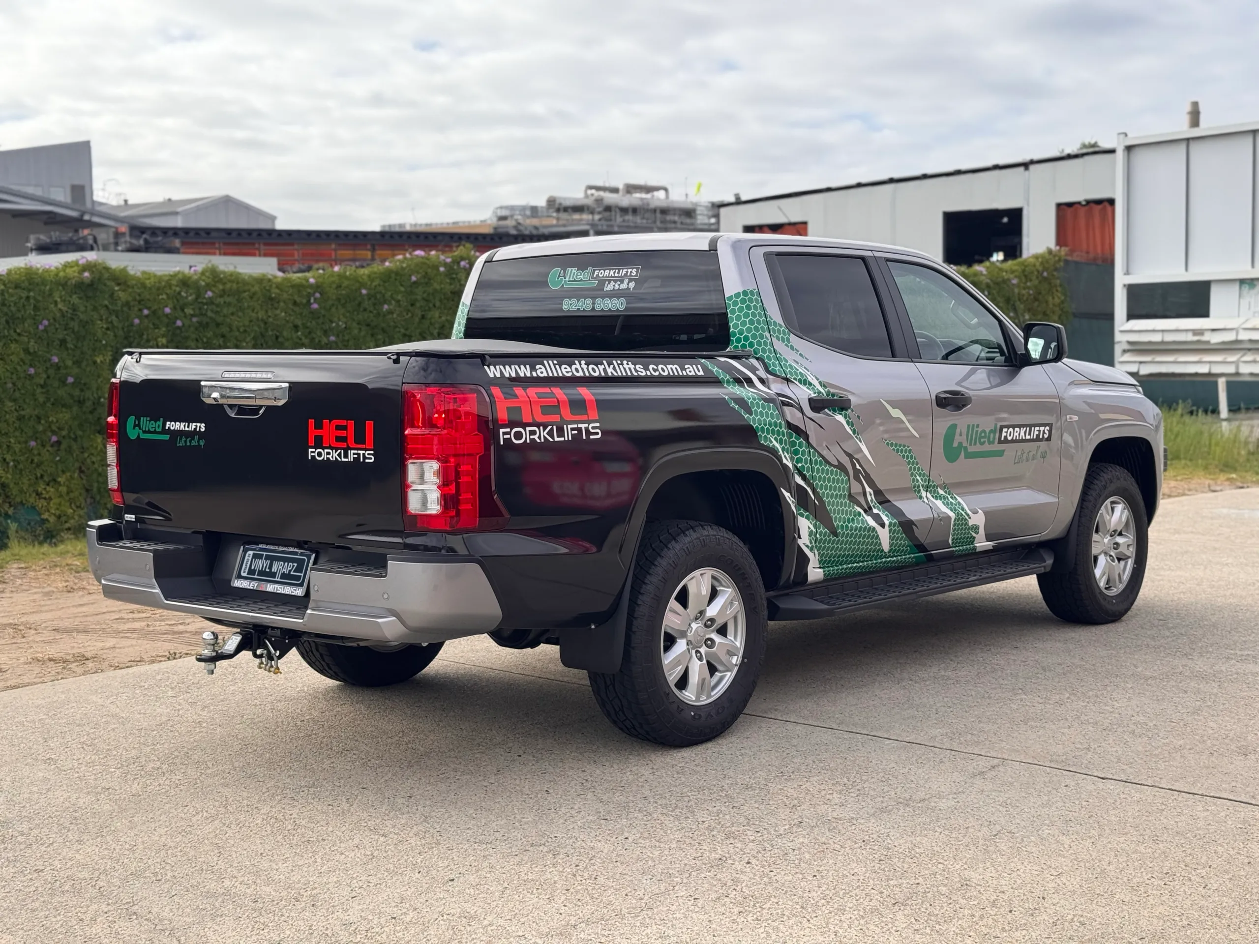 Allied Forklifts Mitsubishi Triton with black, green and white graphics outdoors