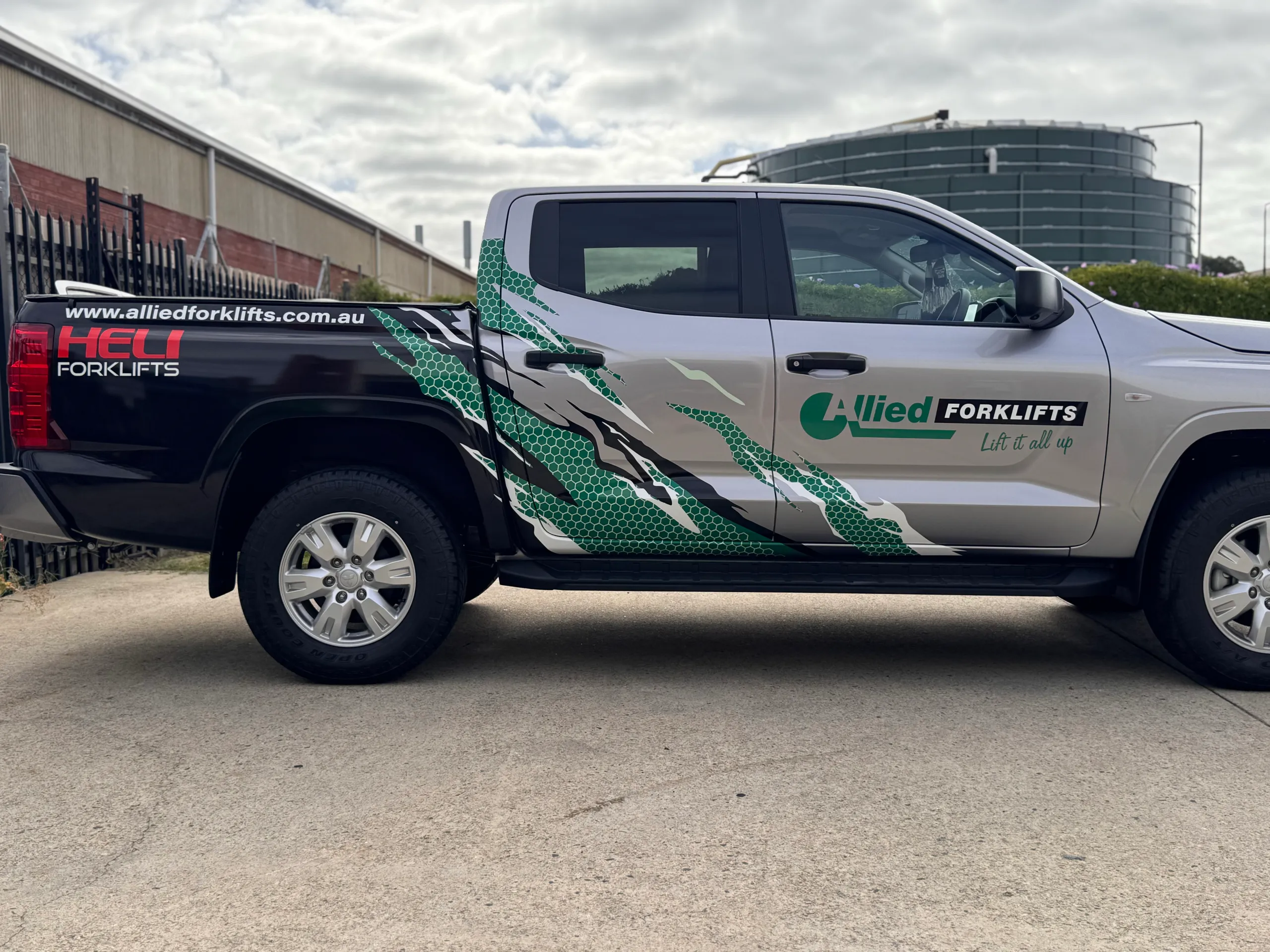 Side view of the Allied Forklifts Triton cab and tray with green and white graphics