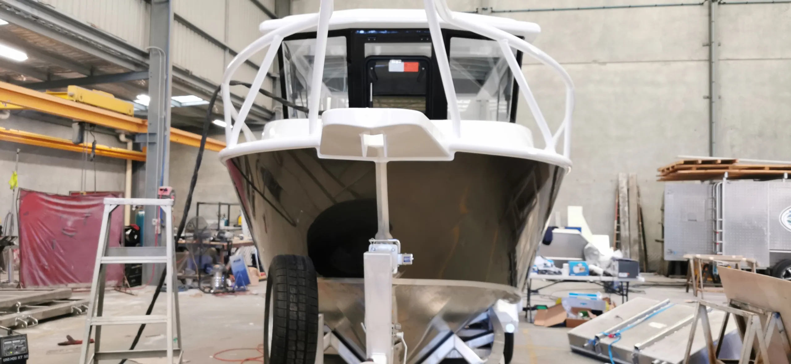 Head-on view of the finished charcoal boat bow beneath white rails