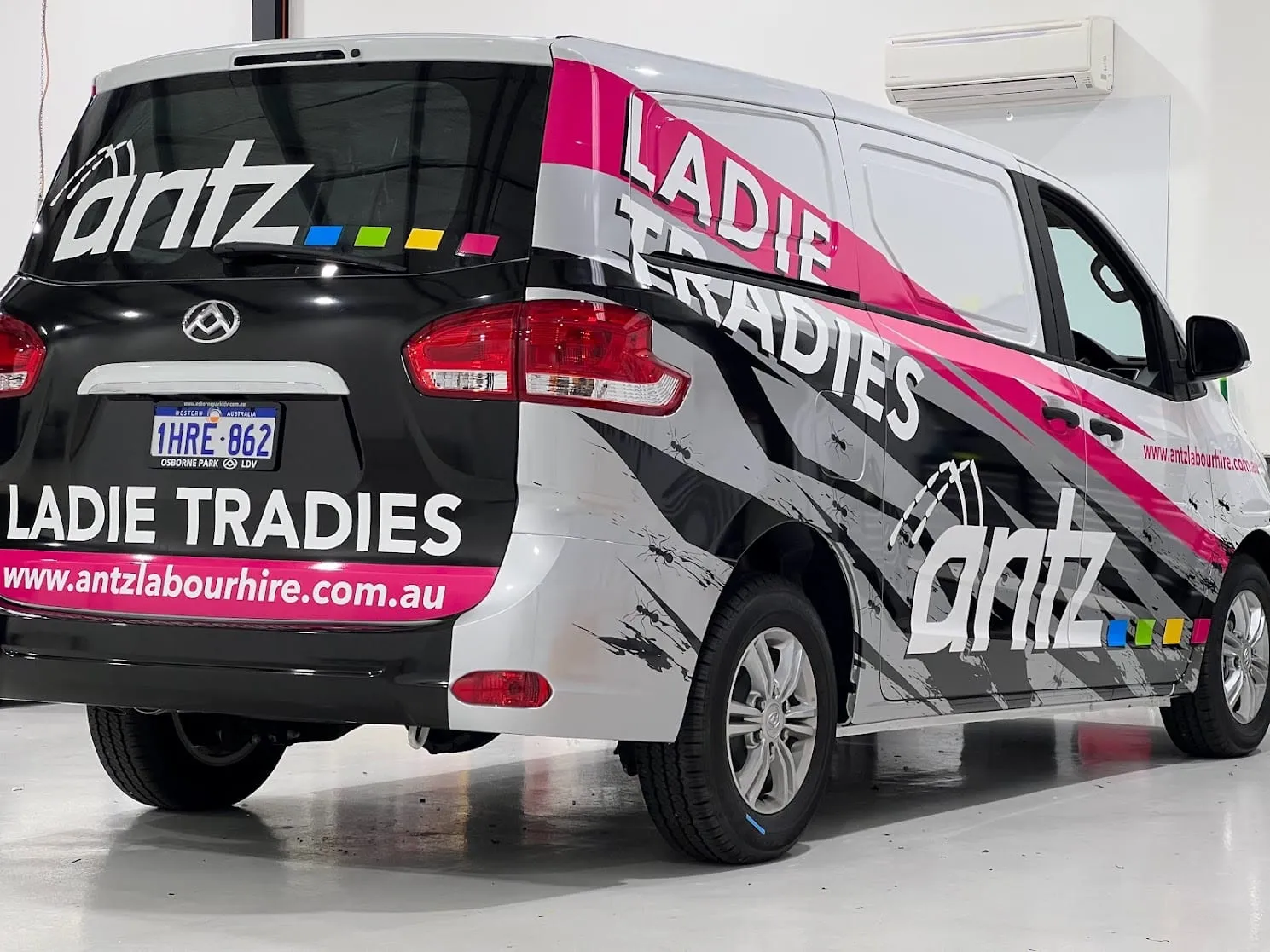 Antz Labour Hire van in a printed black, white and pink partial wrap