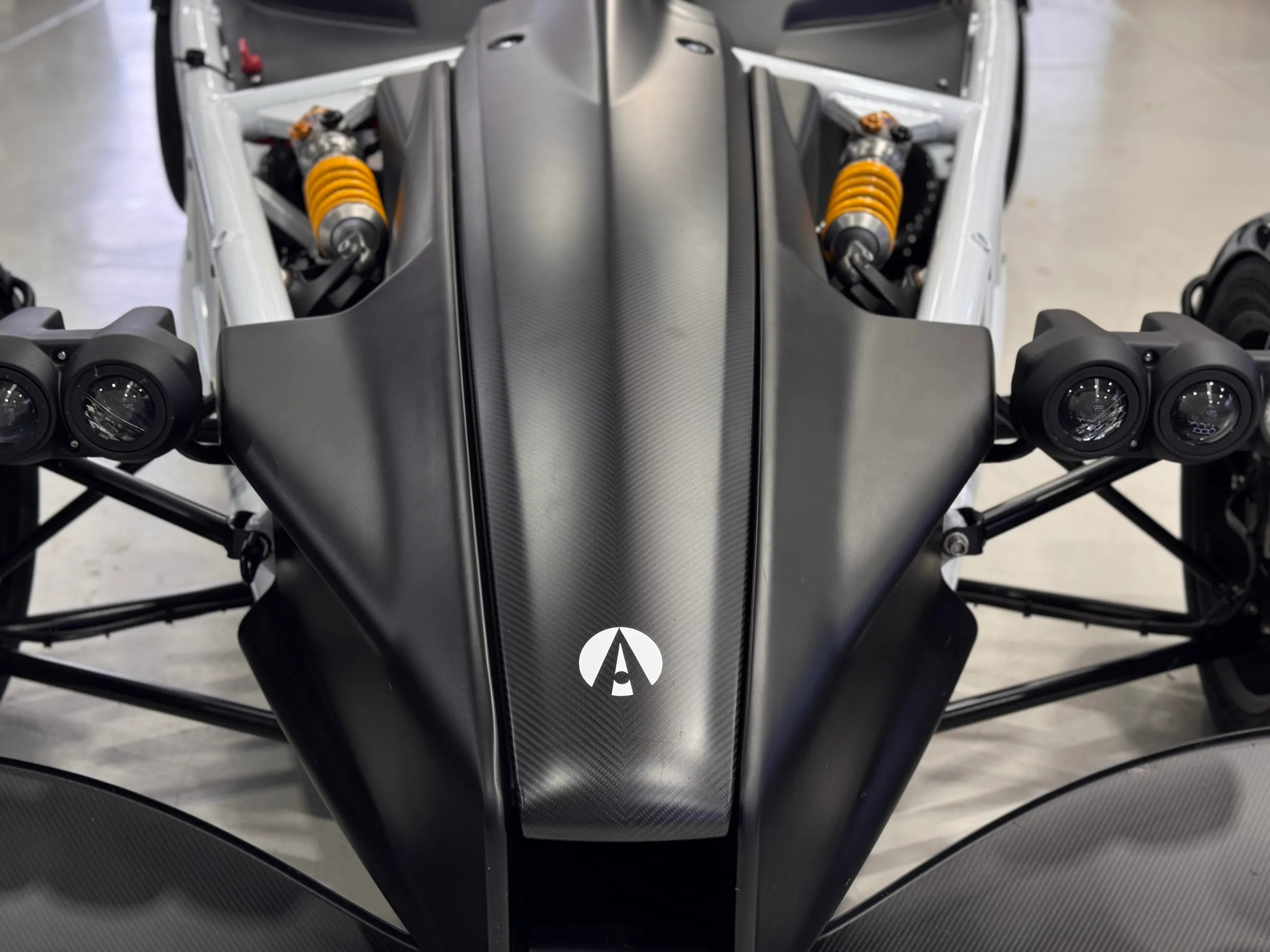 Front detail of the Ariel Atom nose, paired headlights and exposed suspension
