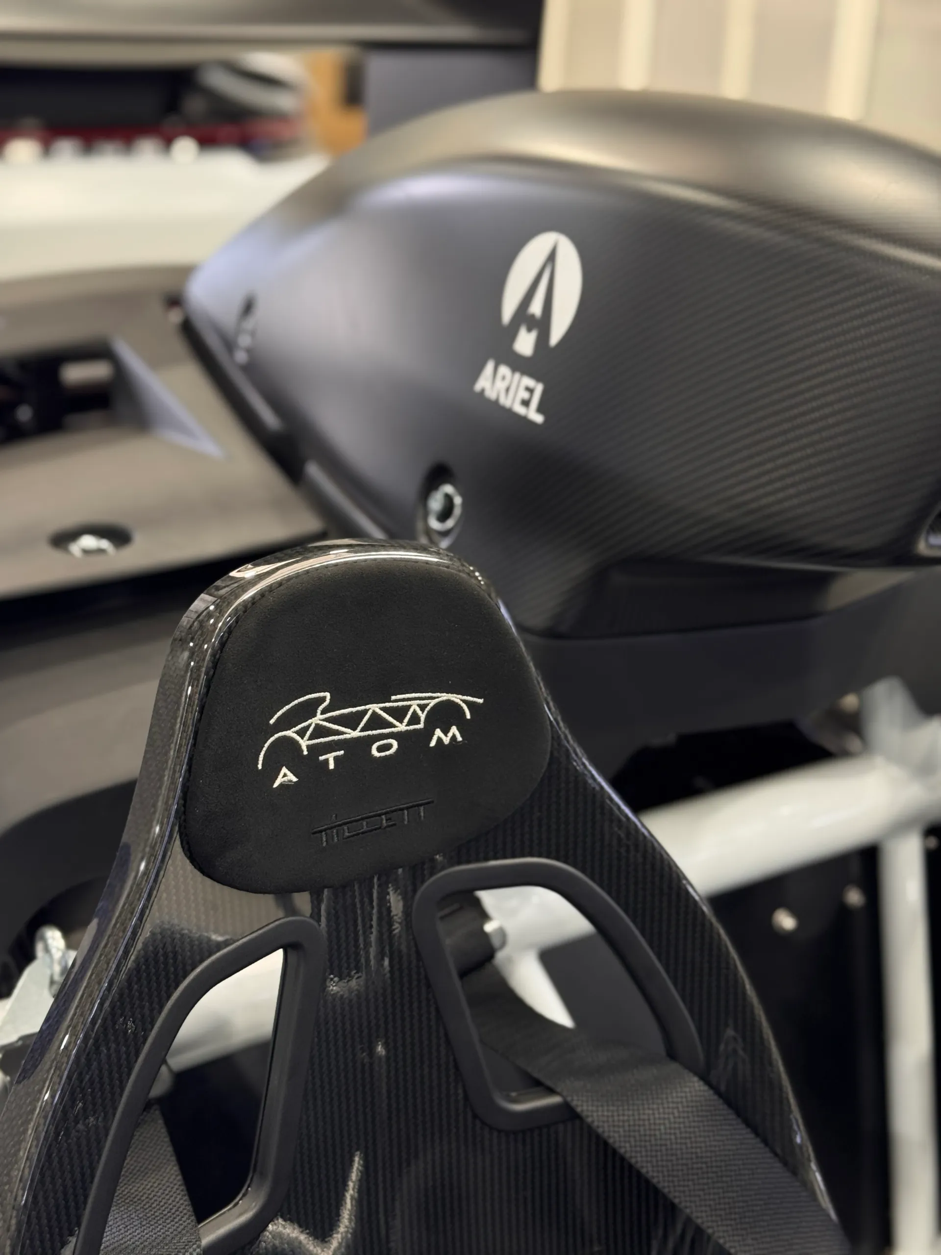 Atom embroidery on a bucket seat with the Ariel-branded intake behind it