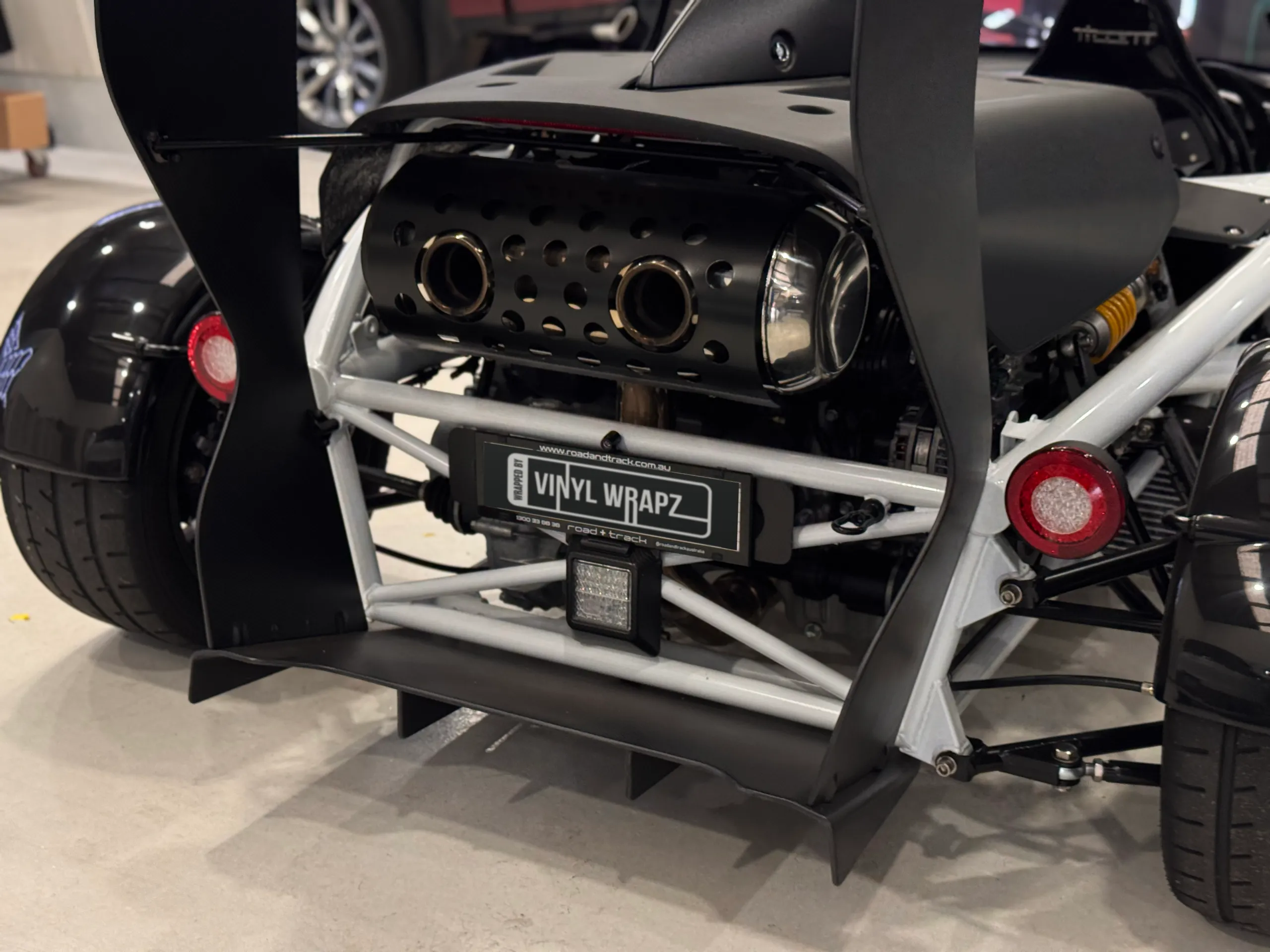 Ariel Atom rear exhaust outlets, round rear lights and wing supports