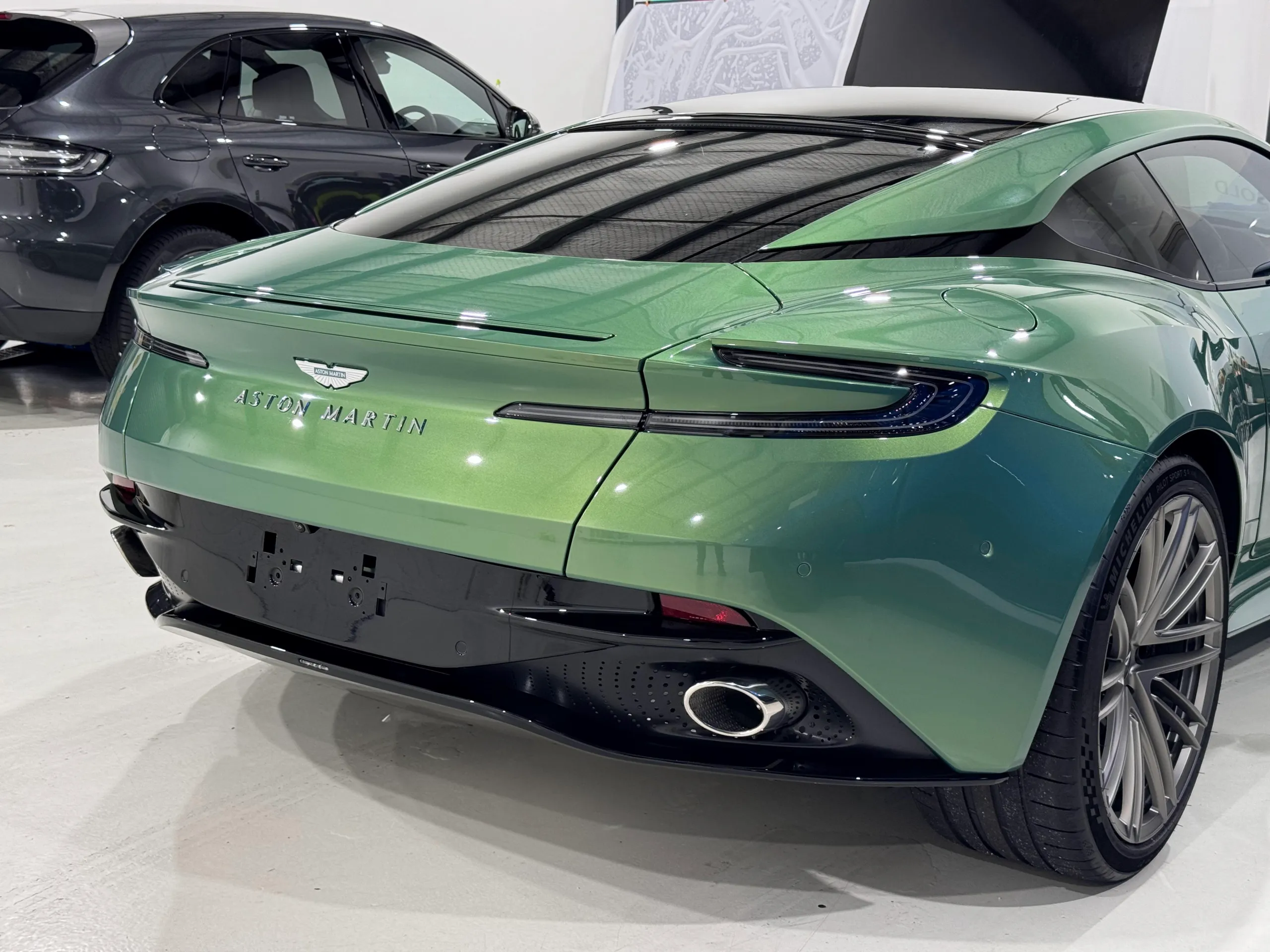 Gloss green Aston Martin DB12 rear lights, boot and bumper inside the workshop