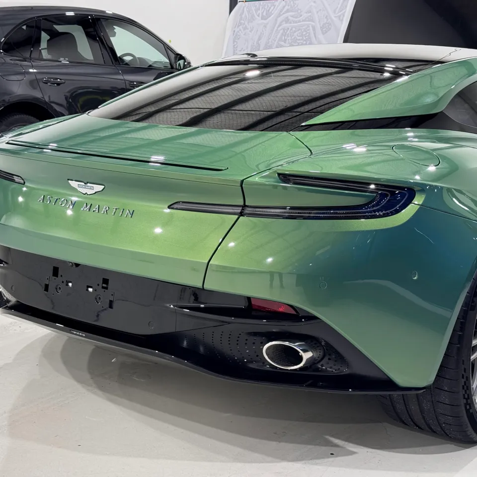 Gloss green Aston Martin DB12 rear lights, boot and bumper inside the workshop