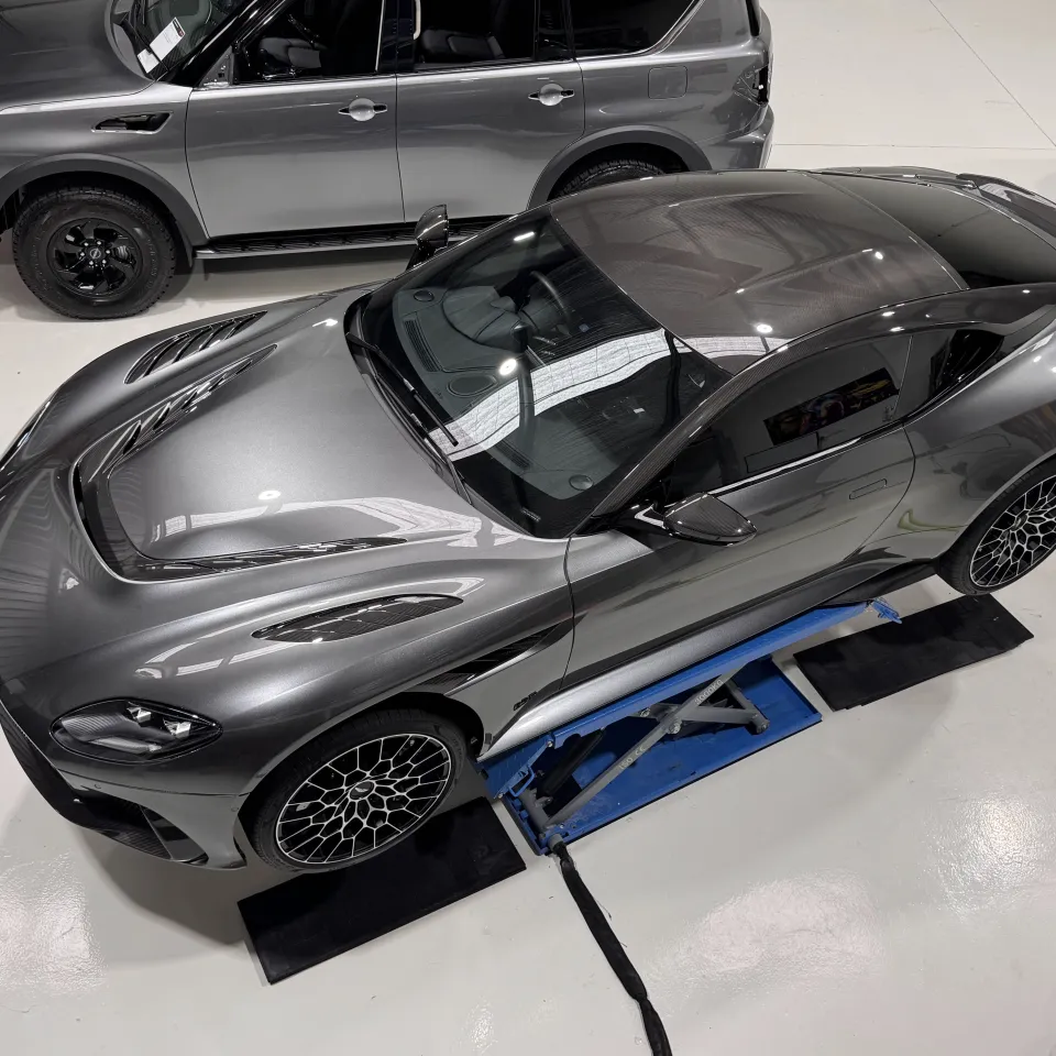 Overhead view of the grey Aston Martin DBS on a workshop lift