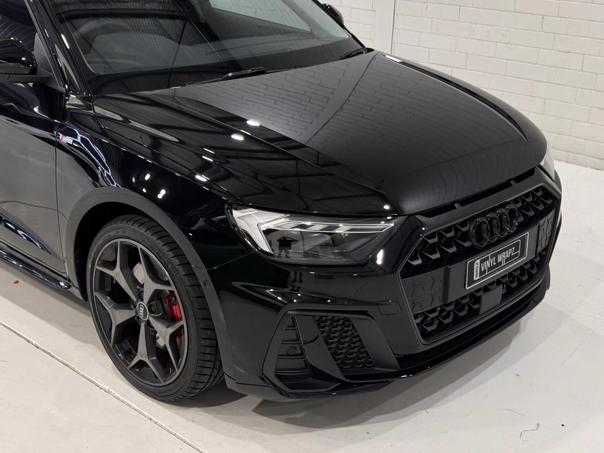 Audi A1 gloss black bonnet, grille and front wheel viewed from above