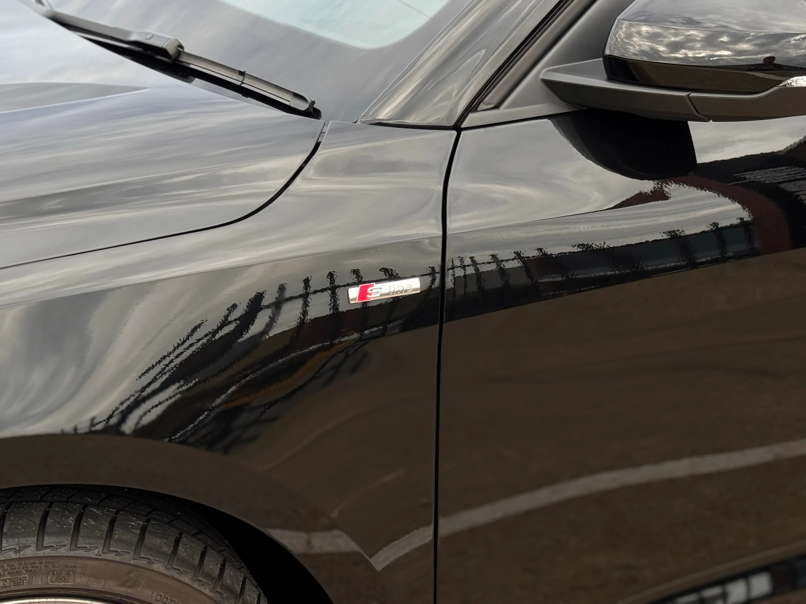 S line badge on the gloss black Audi A1 front guard beside the mirror