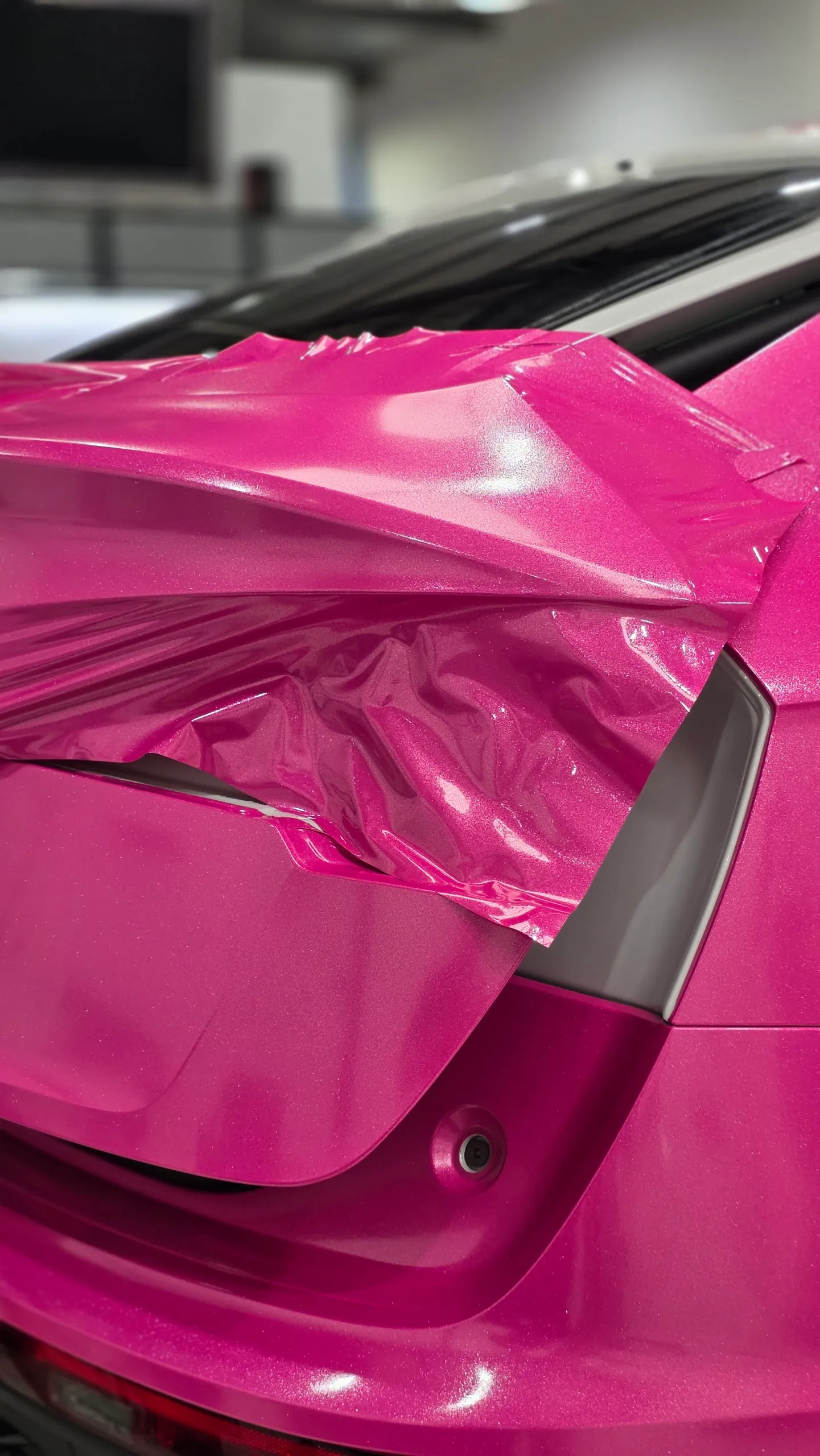 Loose pink wrap film around the Audi Q5 Sportback rear light area during installation