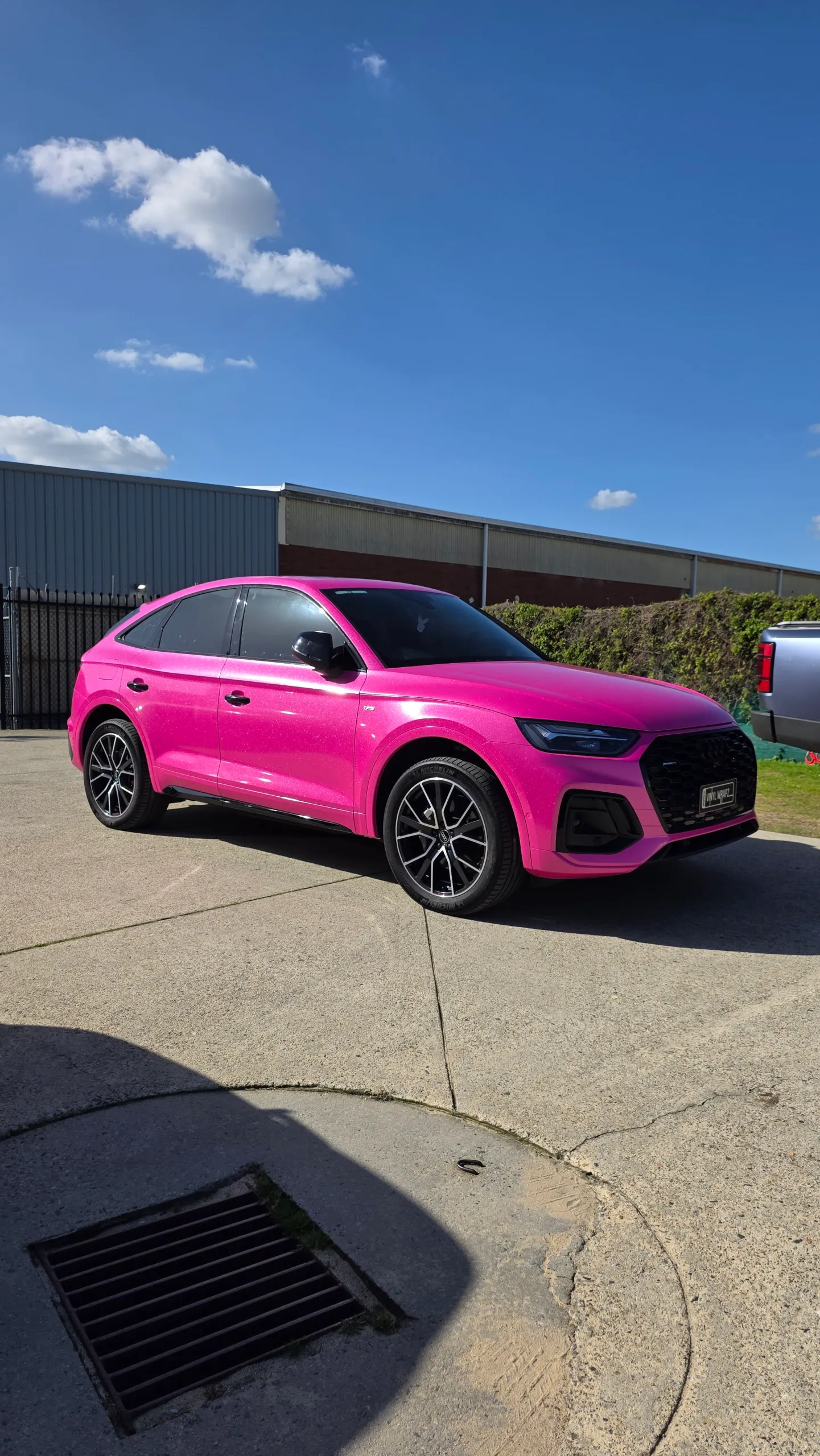 Sparkling pink Audi Q5 Sportback parked outside the workshop, viewed from the front quarter