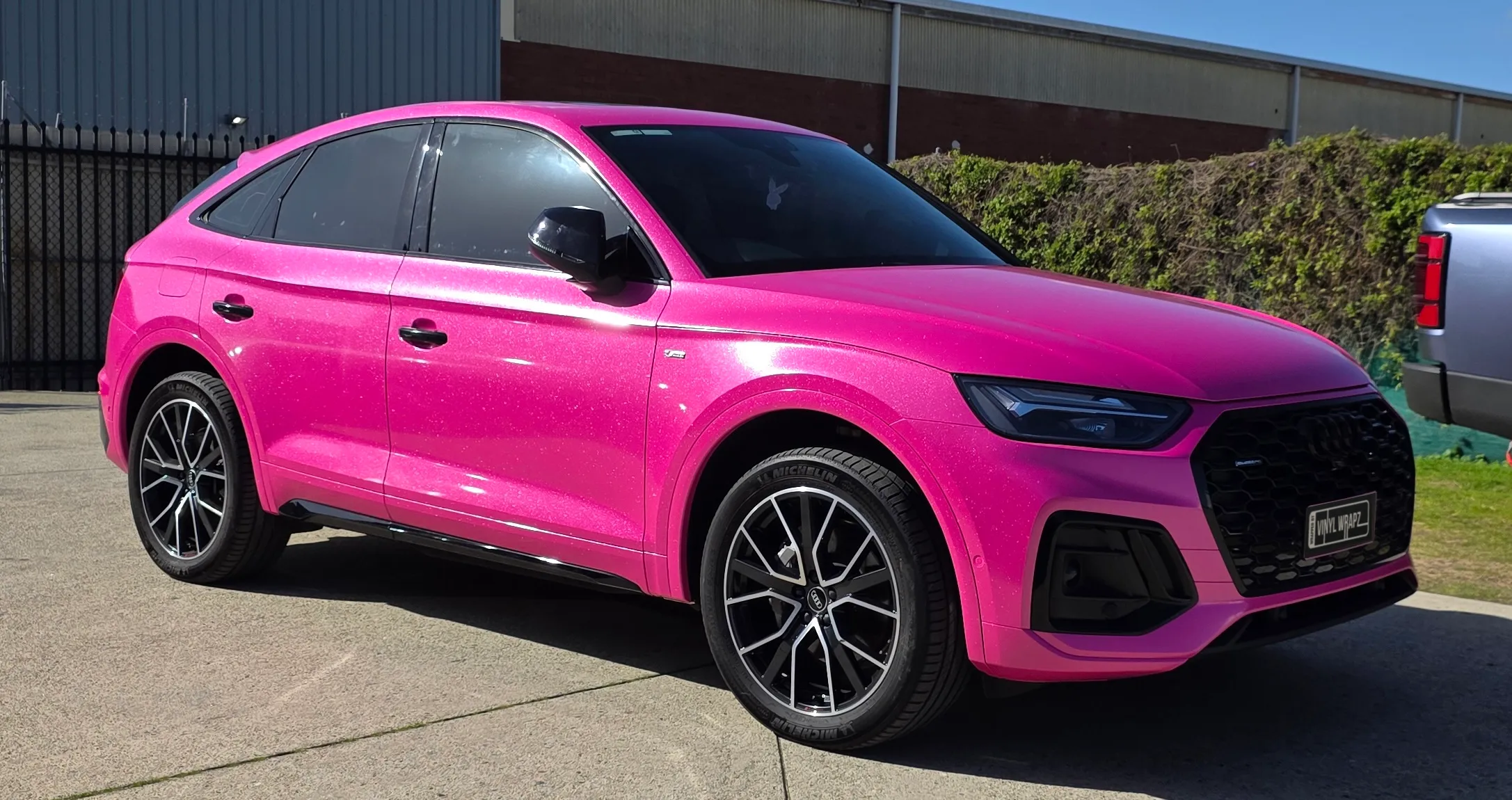 Audi Q5 Sportback in a sparkling pink colour change wrap, front three-quarter view