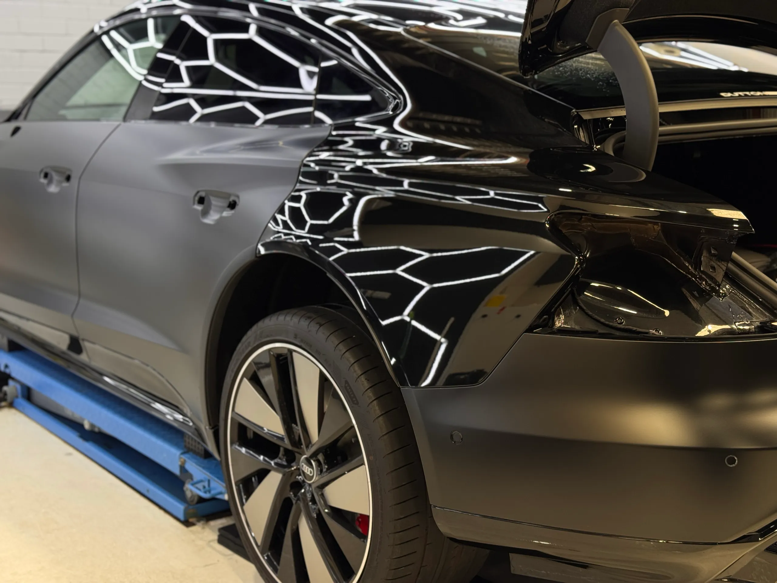 Gloss rear quarter beside matte doors on the Audi RS e-tron GT during film installation
