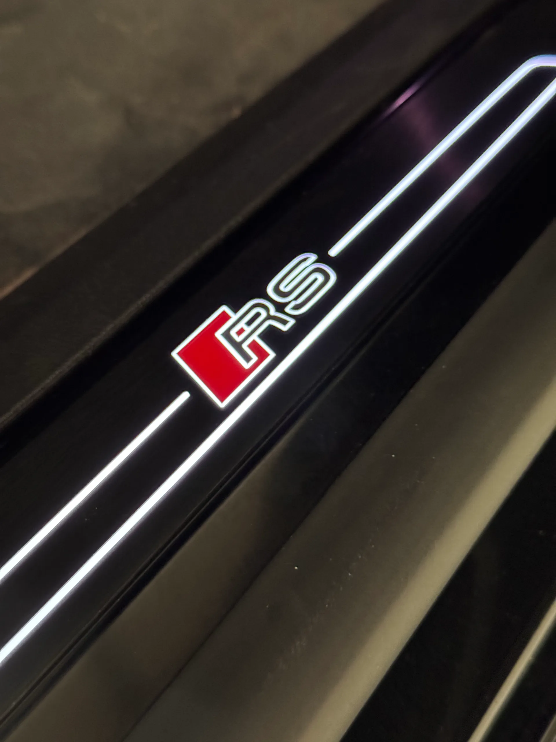 Illuminated RS door-sill badge inside the Audi RS e-tron GT