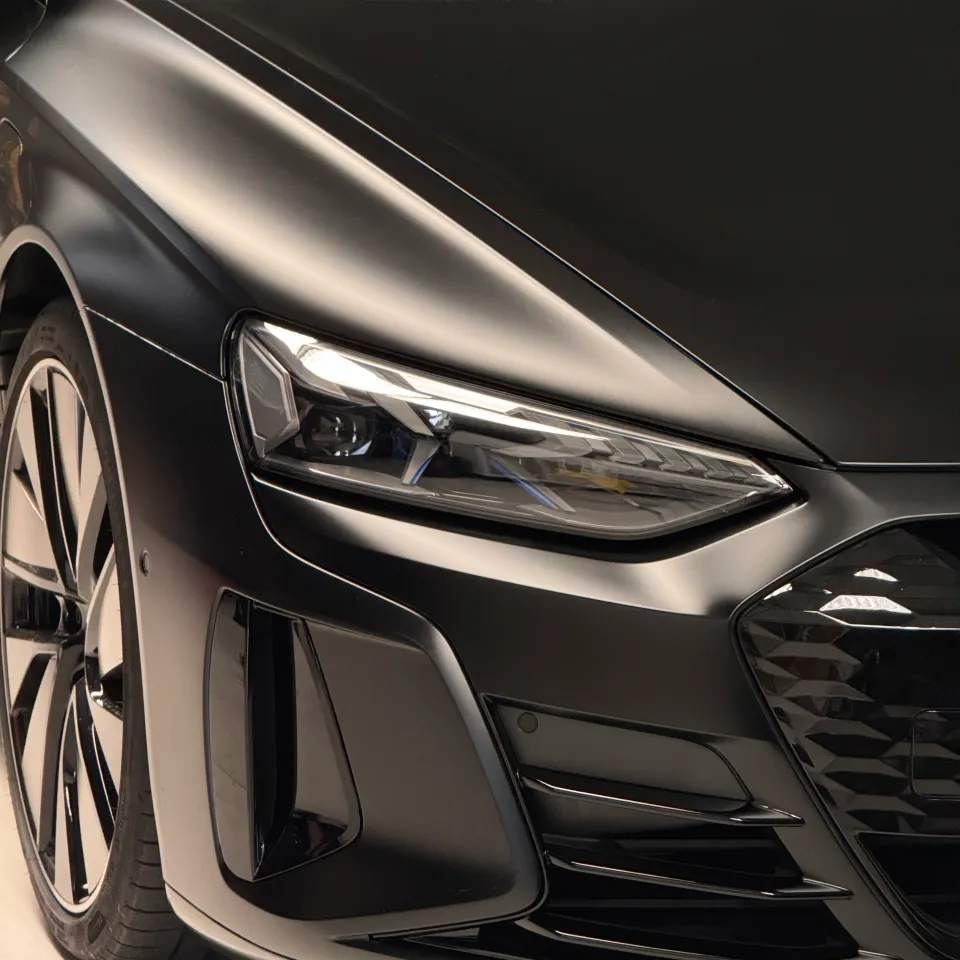 Matte black Audi RS e-tron GT headlight and front bumper in the workshop