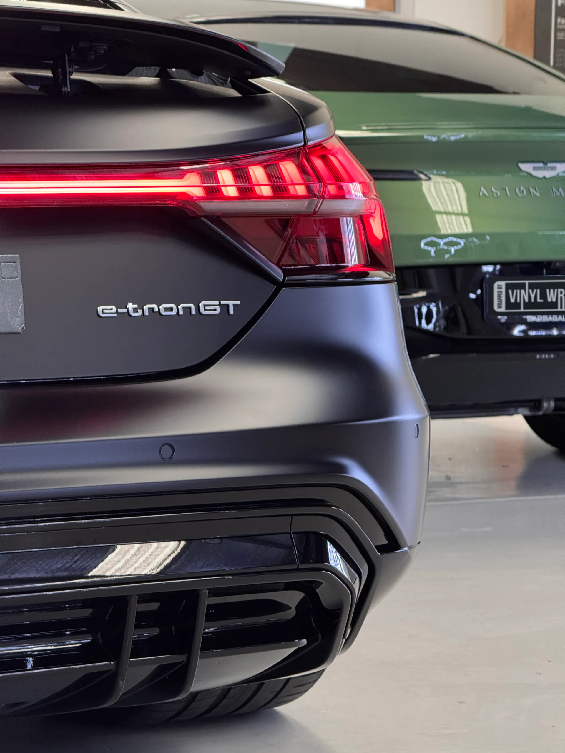 Audi RS e-tron GT rear corner, illuminated tail light and matte black bumper