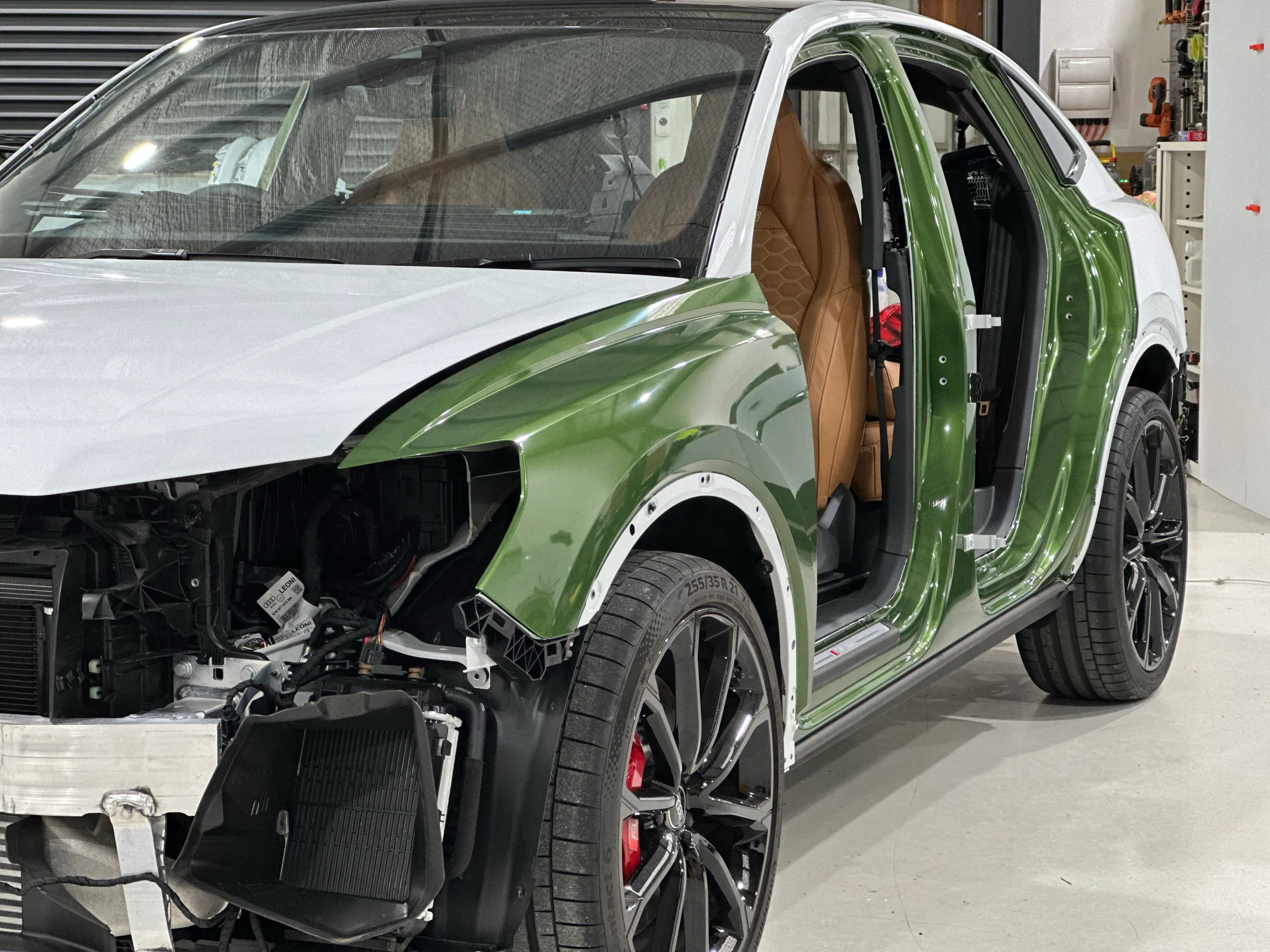 Audi RS Q3 Sportback during its green wrap, with doors, front bumper and headlight removed