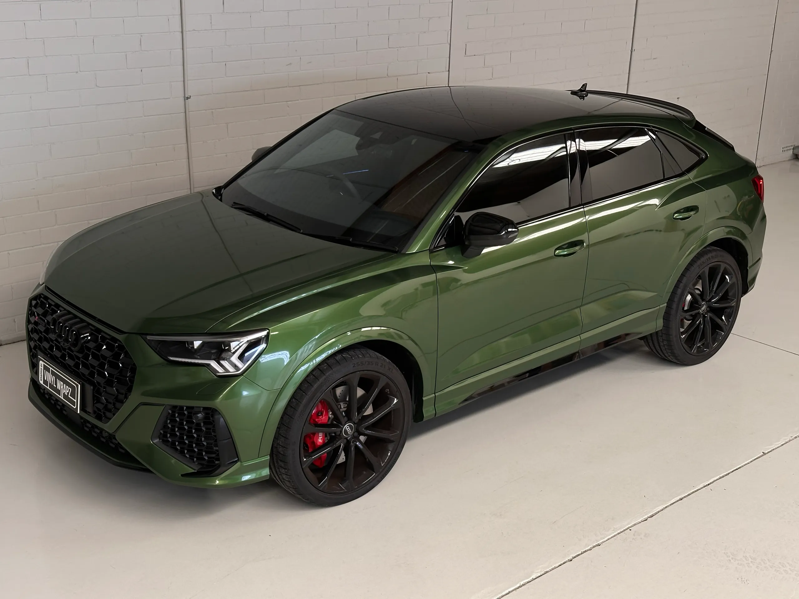 Metallic green Audi RS Q3 Sportback viewed from above at the front quarter in the workshop