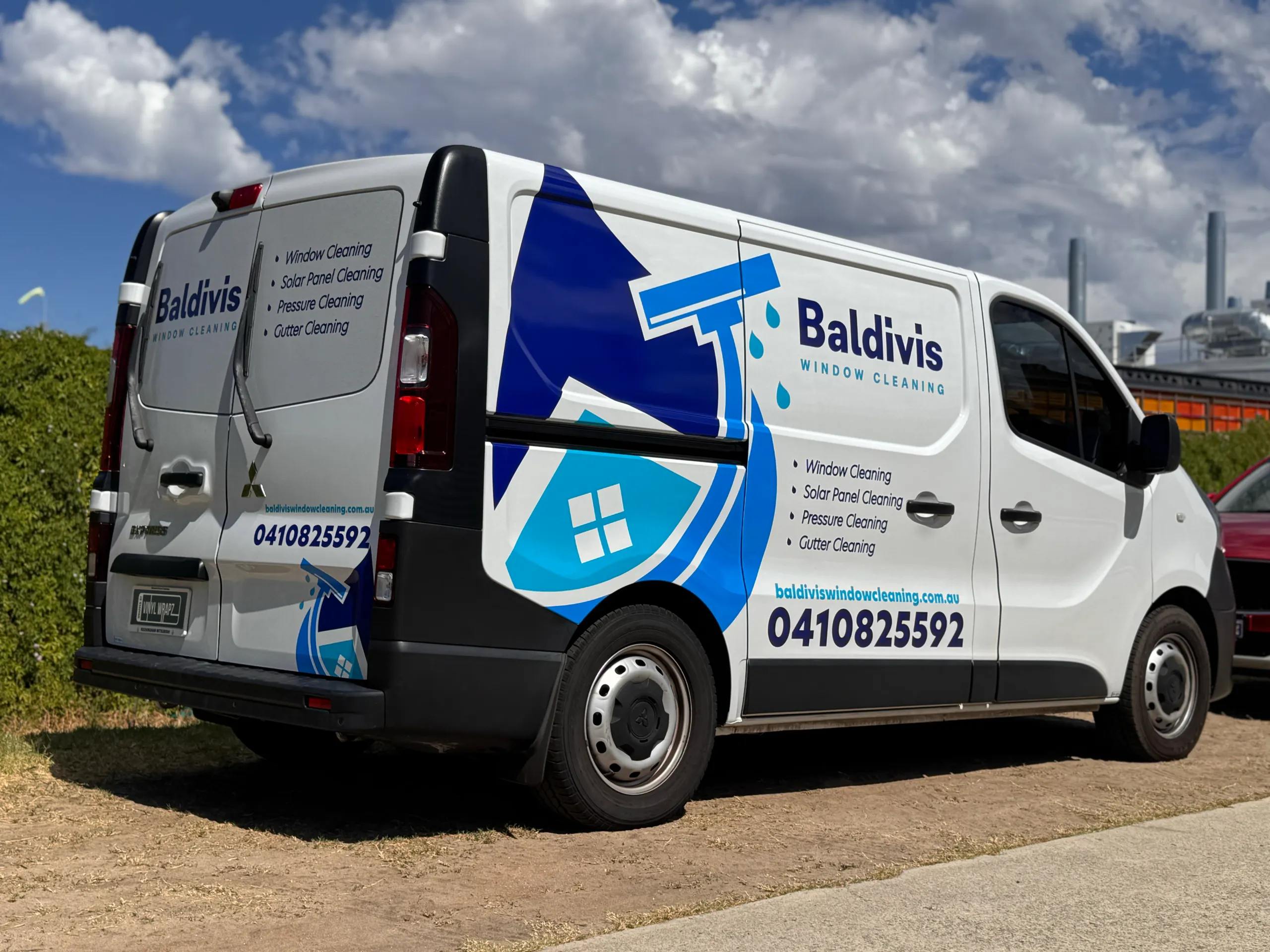 Rear-quarter view of the Baldivis Window Cleaning van showing branding across the side and rear doors