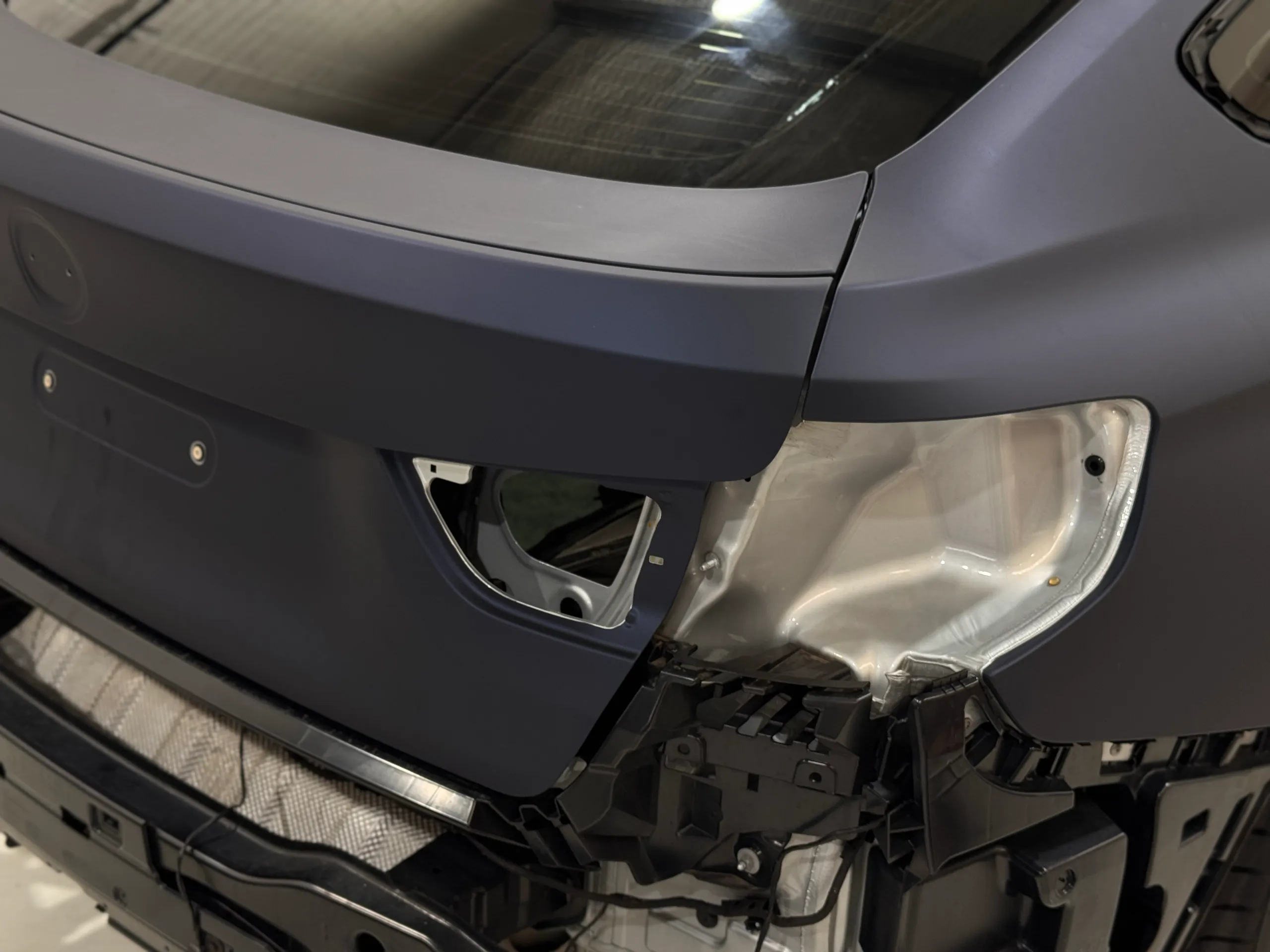 Satin blue-grey film around the BMW Gran Turismo tailgate and empty rear-light opening