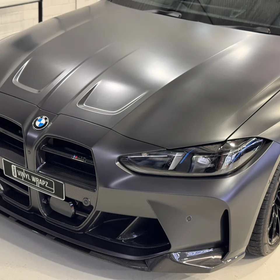 Elevated view of the satin dark grey BMW M4 Competition bonnet, grille and front bumper