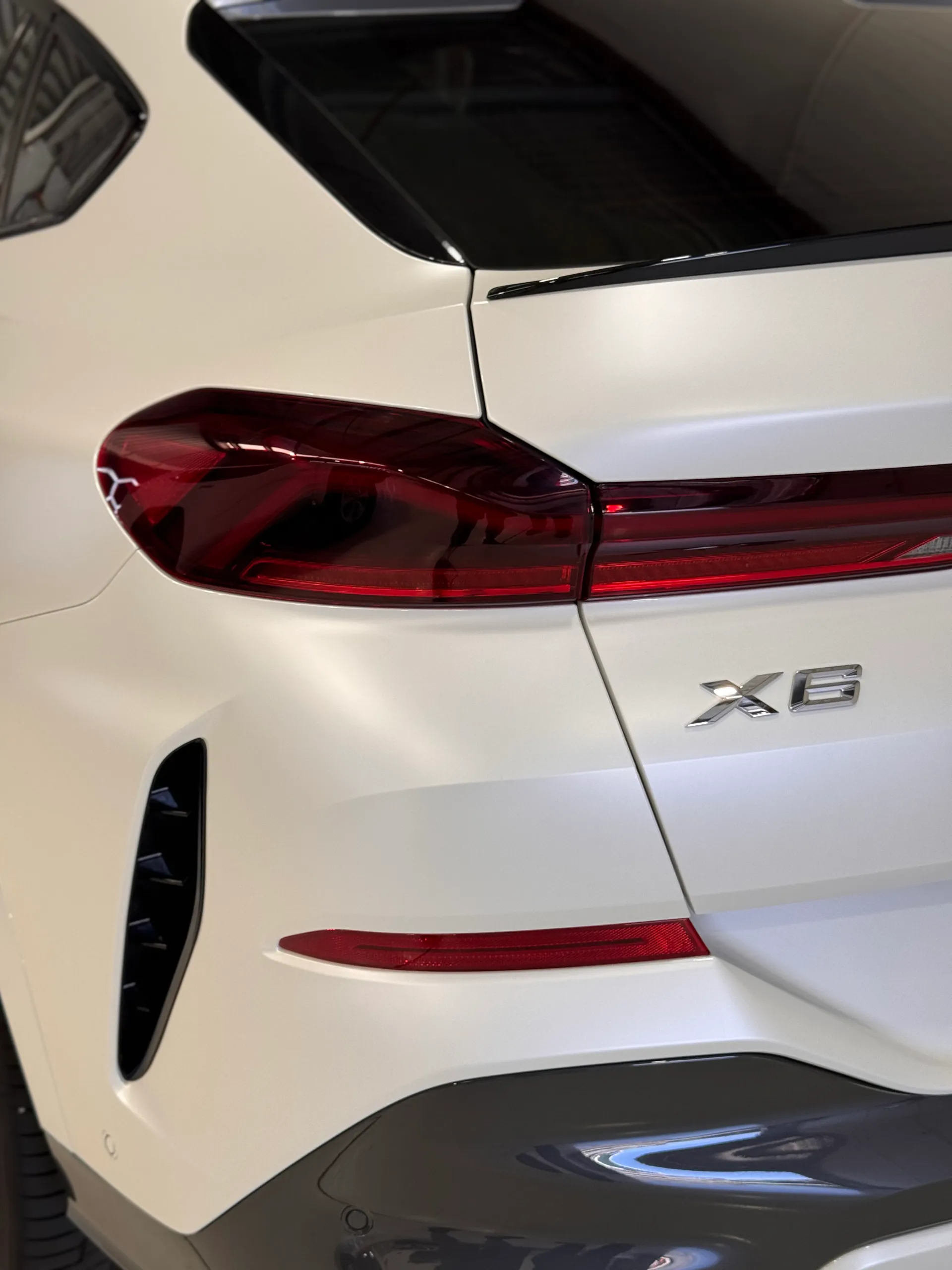 BMW X6 rear light, white tailgate and dark rear glass in the workshop