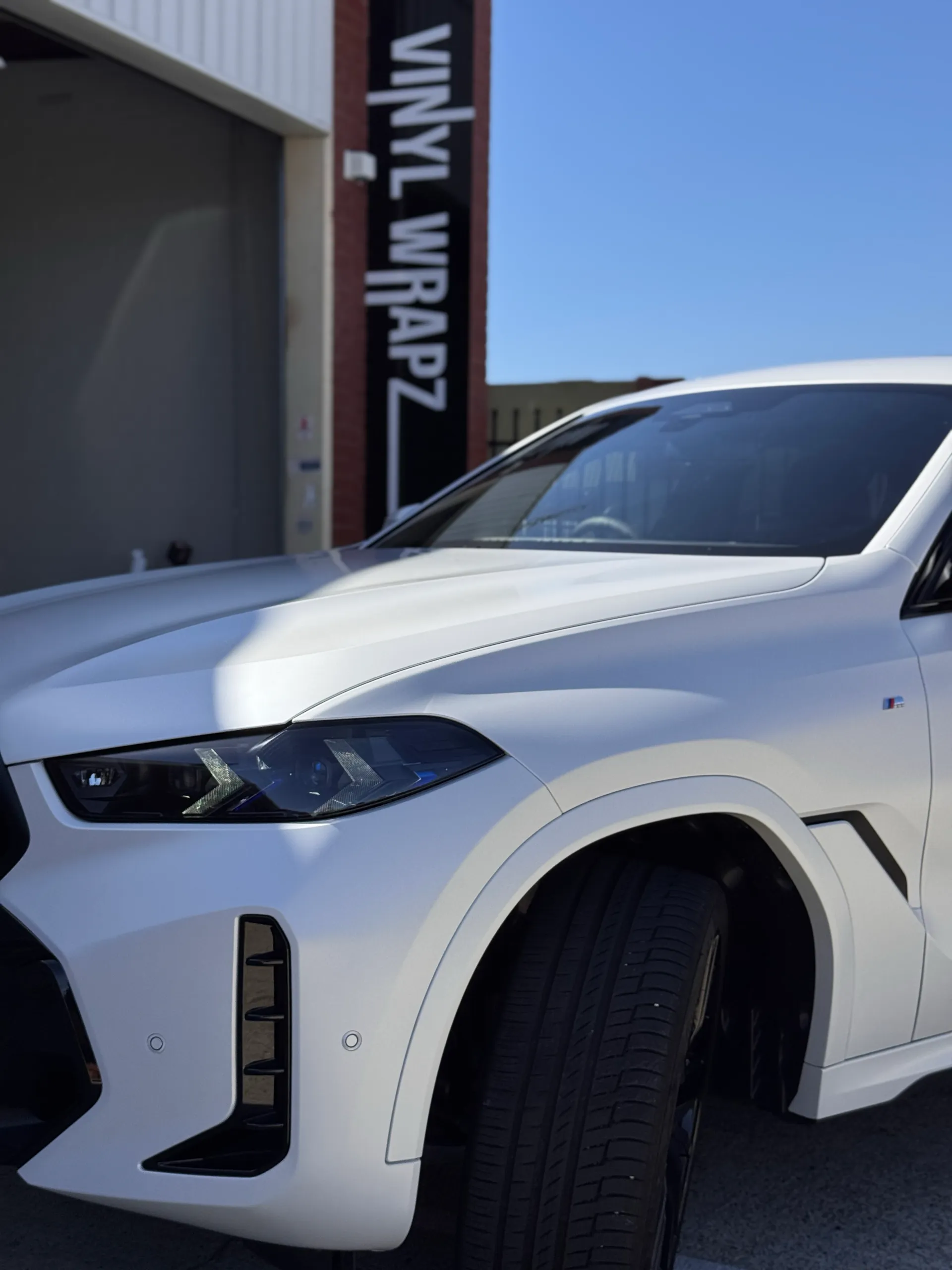 BMW X6 headlight, bonnet and front guard in satin white outdoors