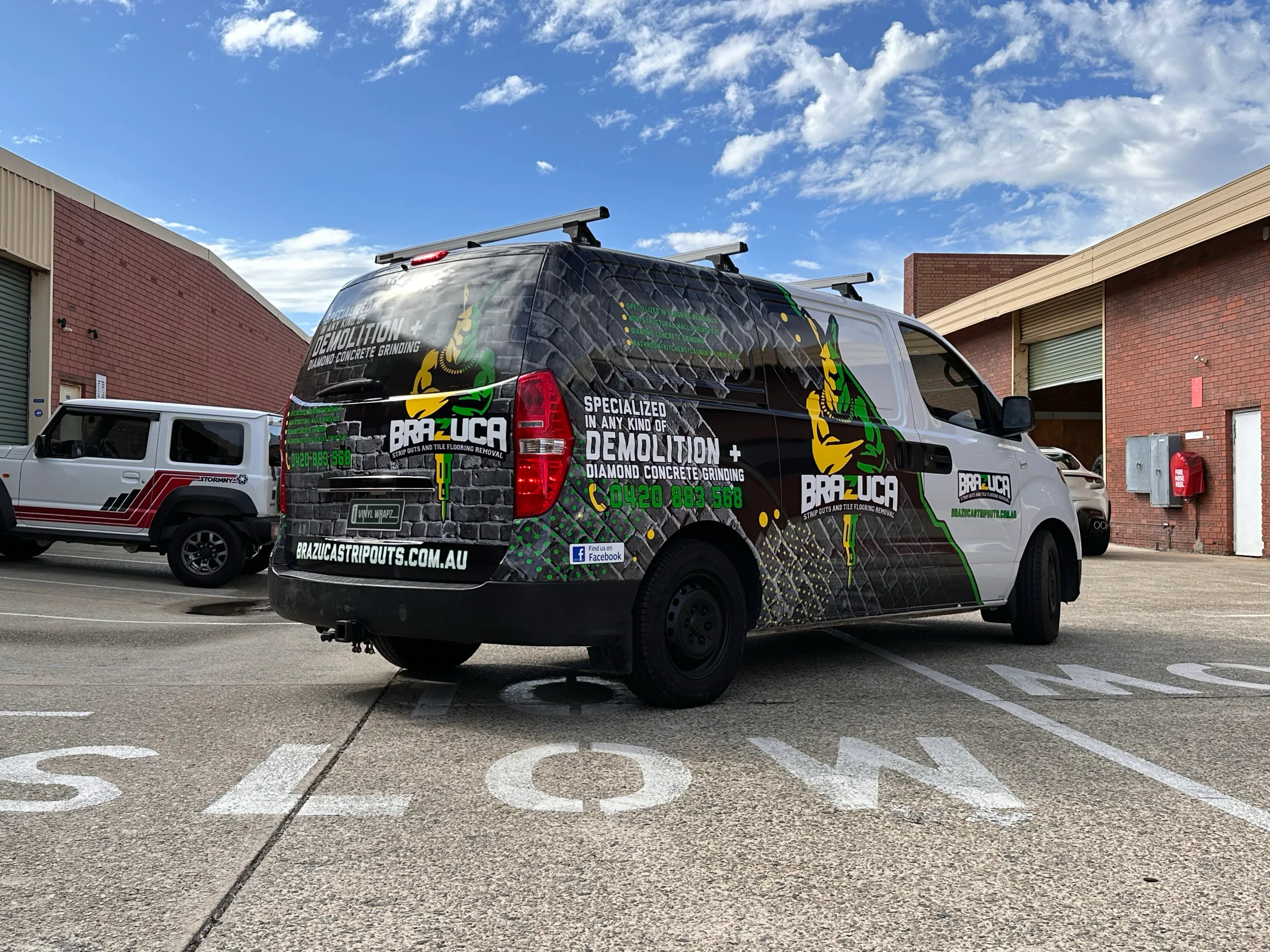 Brazuca Hyundai iLoad parked outside the workshop with black, green and yellow graphics