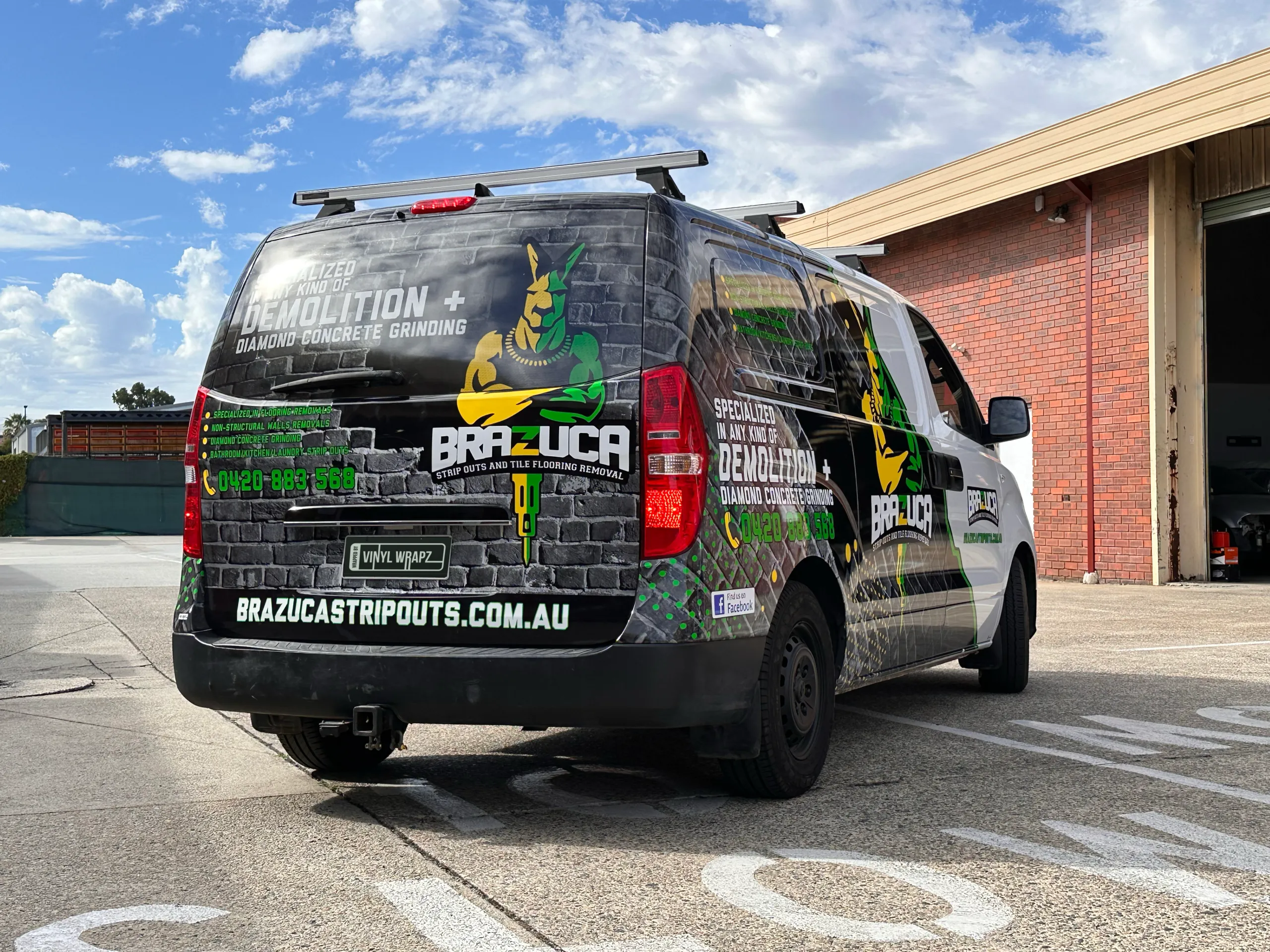 Low rear-quarter view of the Brazuca Hyundai iLoad with printed brickwork and demolition branding