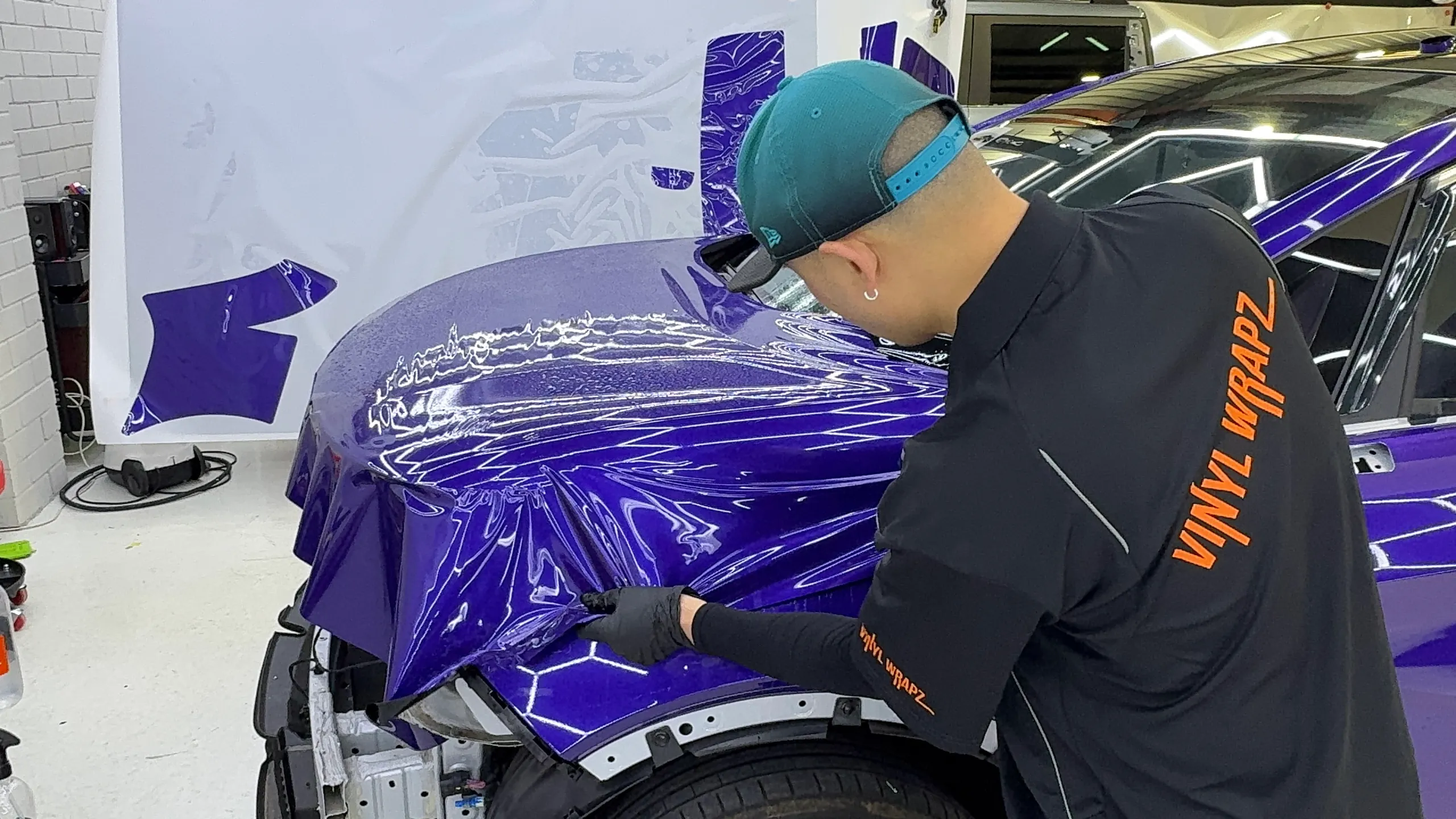 Installer fitting purple film over the BYD Atto 3 front guard