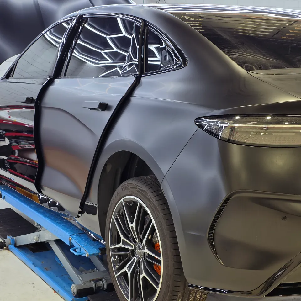 BYD Seal during satin conversion with a door and bonnet open and some panels still glossy