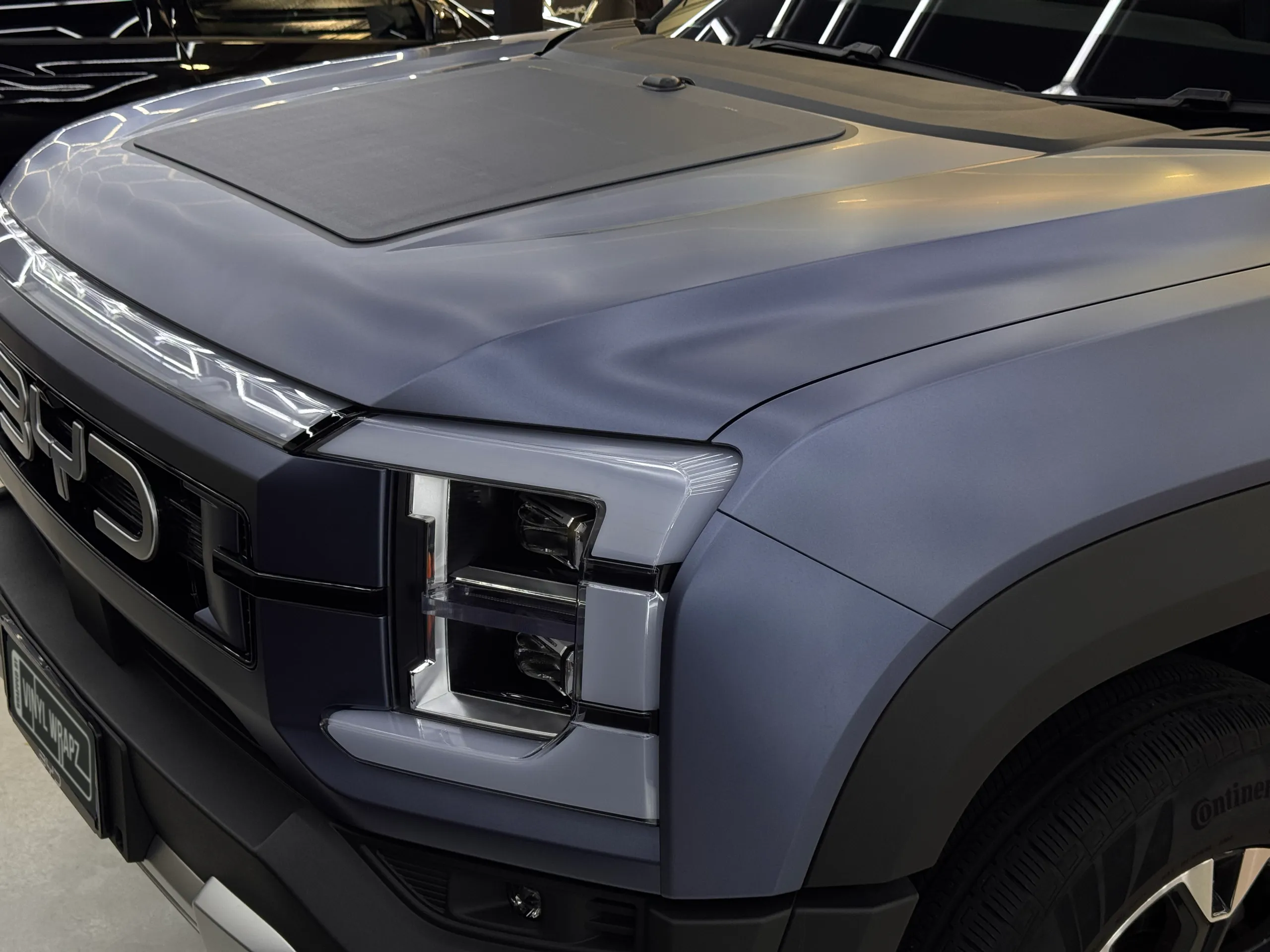 Matte blue-grey BYD Shark bonnet, headlight and front grille in the workshop