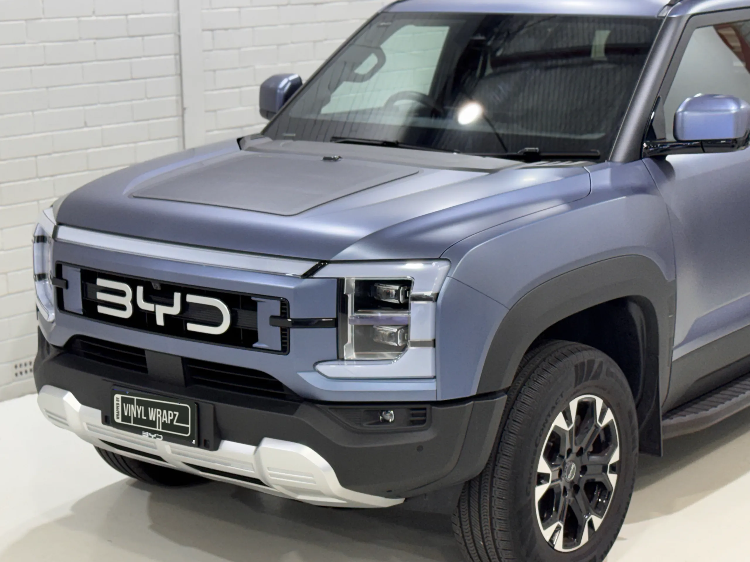 BYD Shark front grille, headlight and wheel with matte blue-grey bodywork