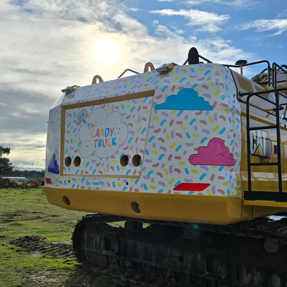 Completed Candy Truck graphics on the tracked Caterpillar excavator