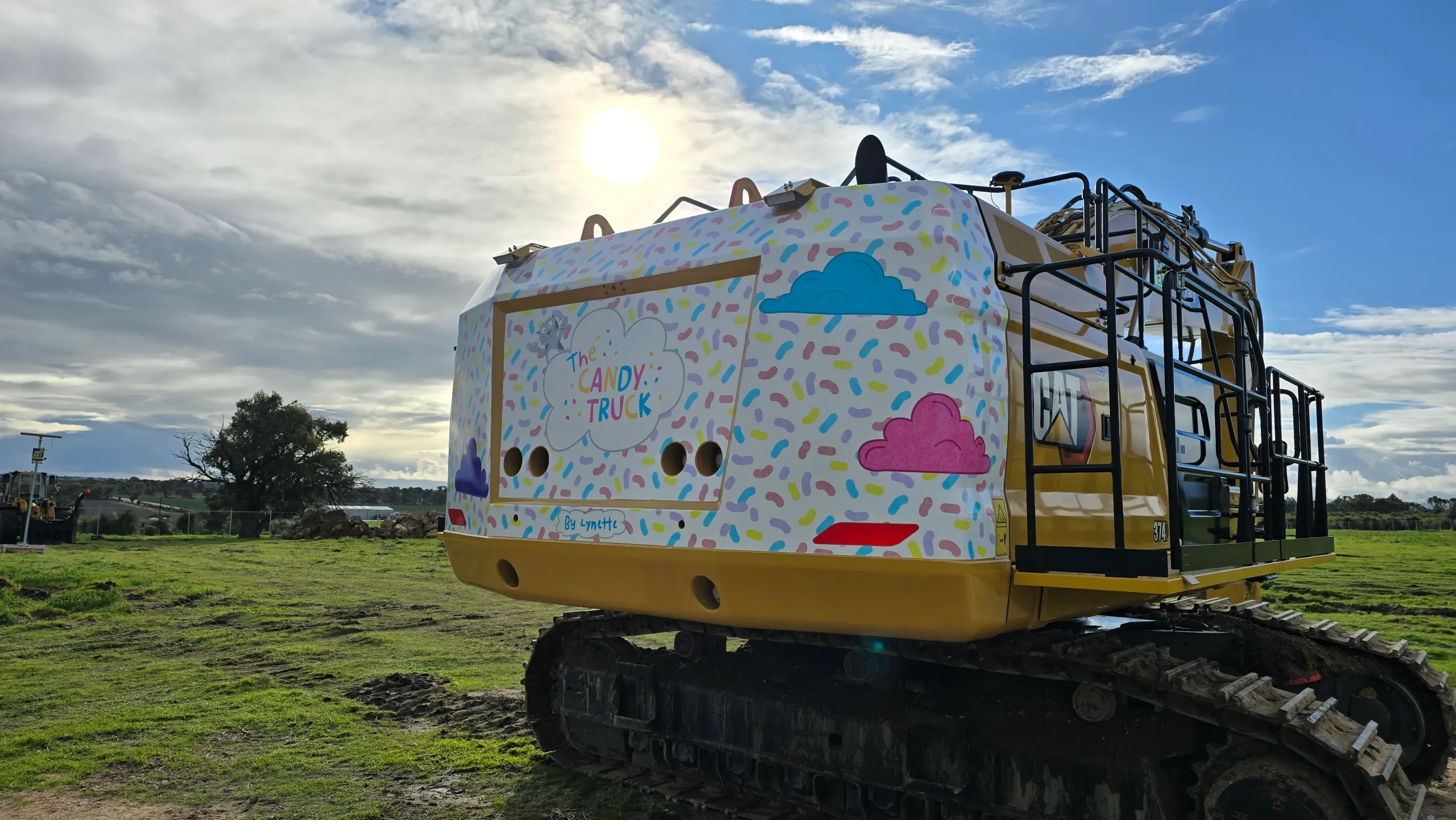 Completed Candy Truck graphics on the tracked Caterpillar excavator