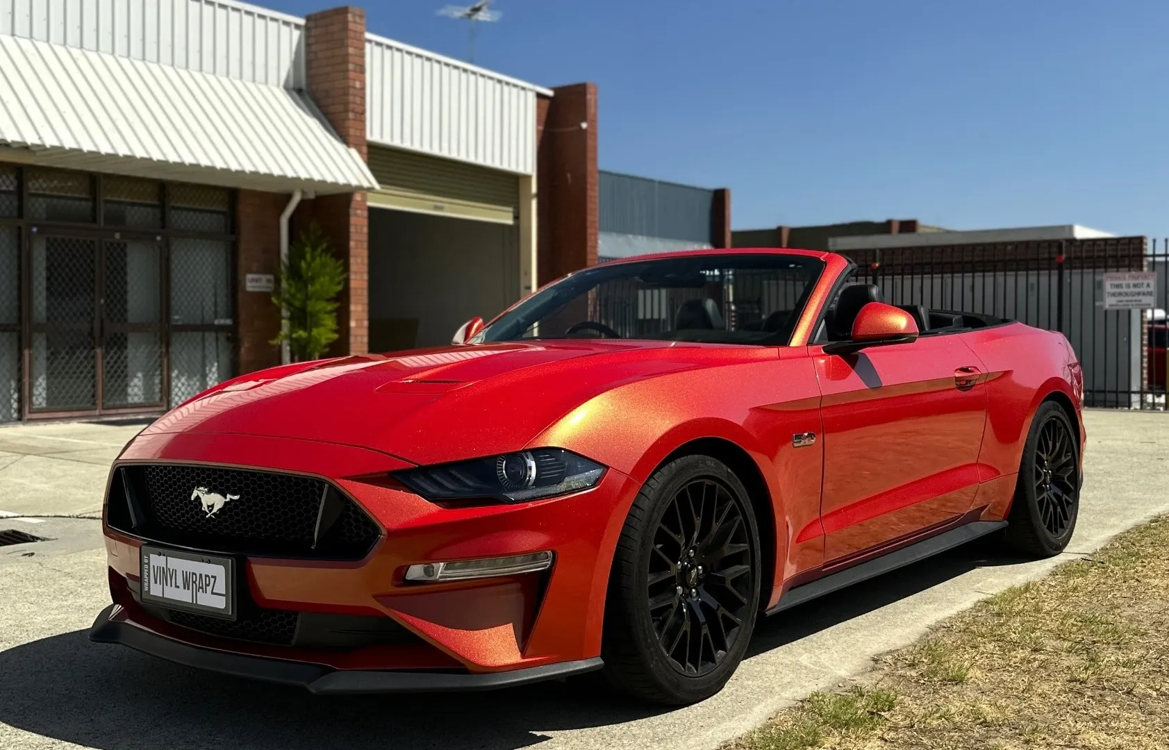 Ford Mustang GT convertible in an Orafol sunset colour-shift wrap at sunset