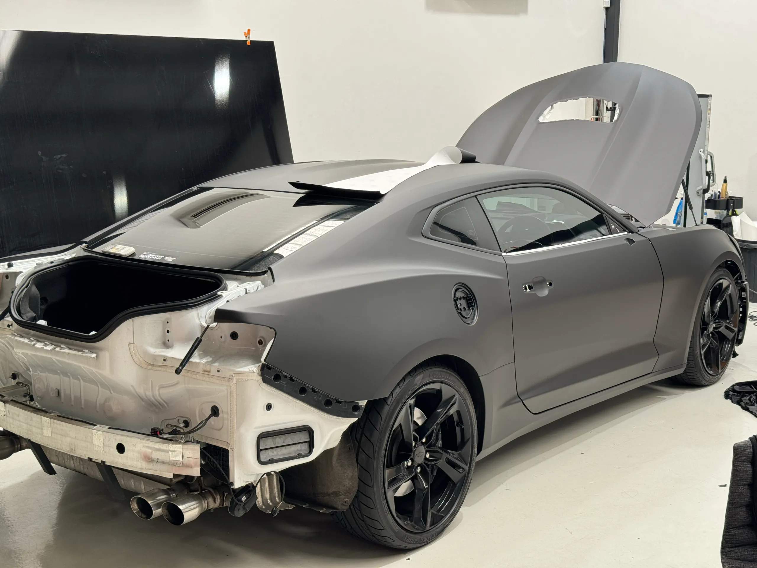 Camaro during installation with rear bumper and boot lid removed and bonnet raised