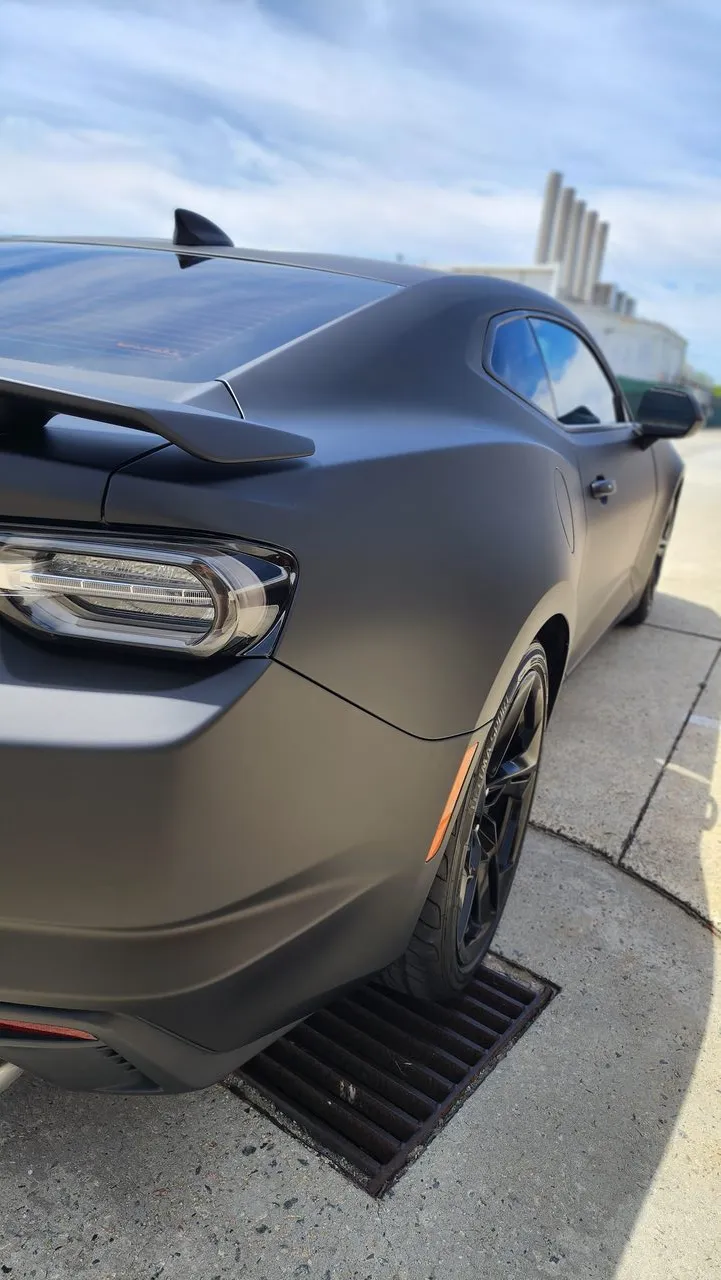 Matte black Chevrolet Camaro rear quarter, tail light and side detail