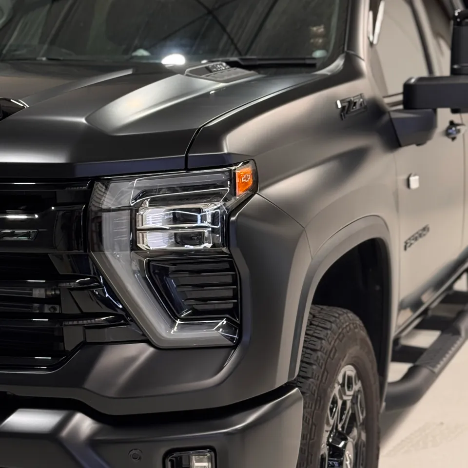 Matte Silverado front corner showing the headlight, guard and front wheel