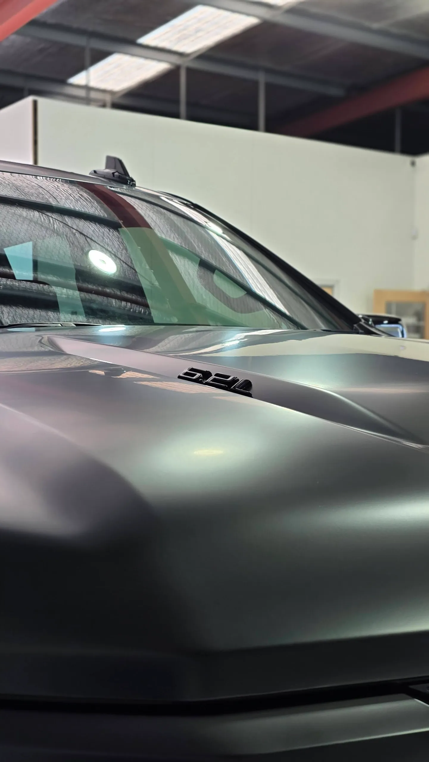 Satin black Chevrolet Silverado bonnet and windscreen in the workshop