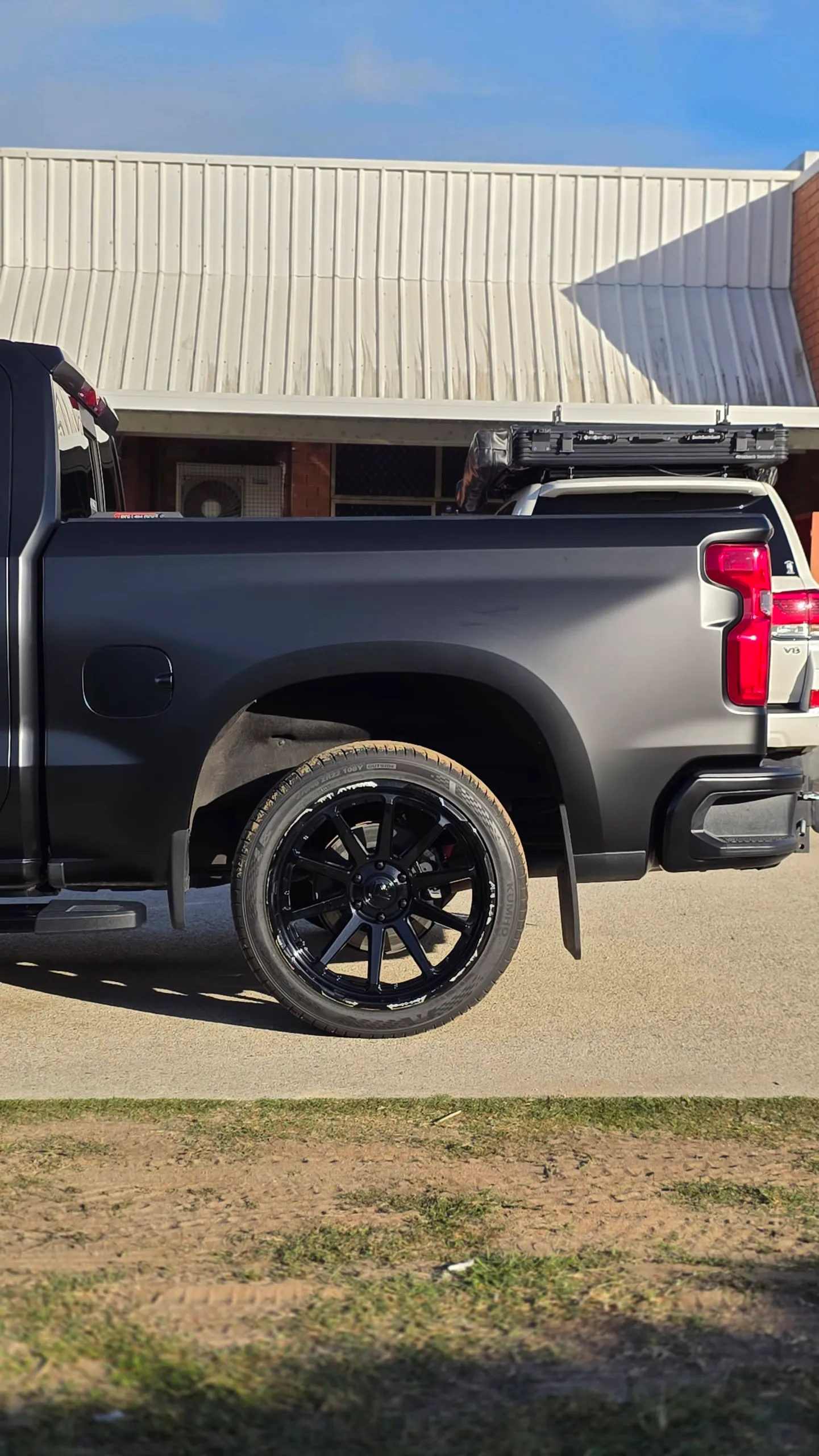 Chevrolet Silverado tray side and rear wheel in a satin black finish outdoors